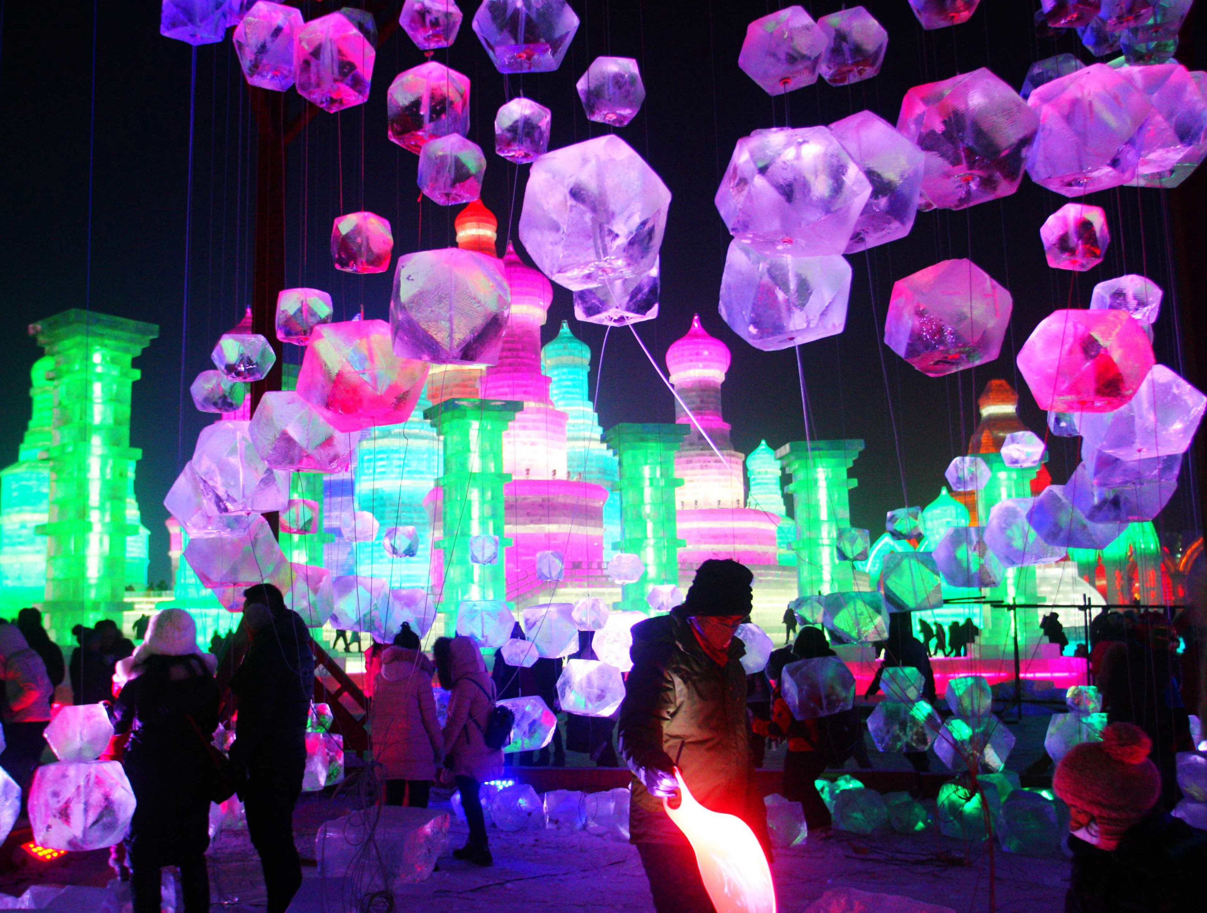 HARBIN, CHINA - DECEMBER 22: (CHINA OUT) Tourists play in the Harbin Ice And Snow World during its test run on December 22, 2015 in Harbin, Heilongjiang Province of China. The 17th Harbin Ice And Snow World would run from December 25, 2015 to February 25, 2016. (Photo by ChinaFotoPress/ChinaFotoPress via Getty Images)