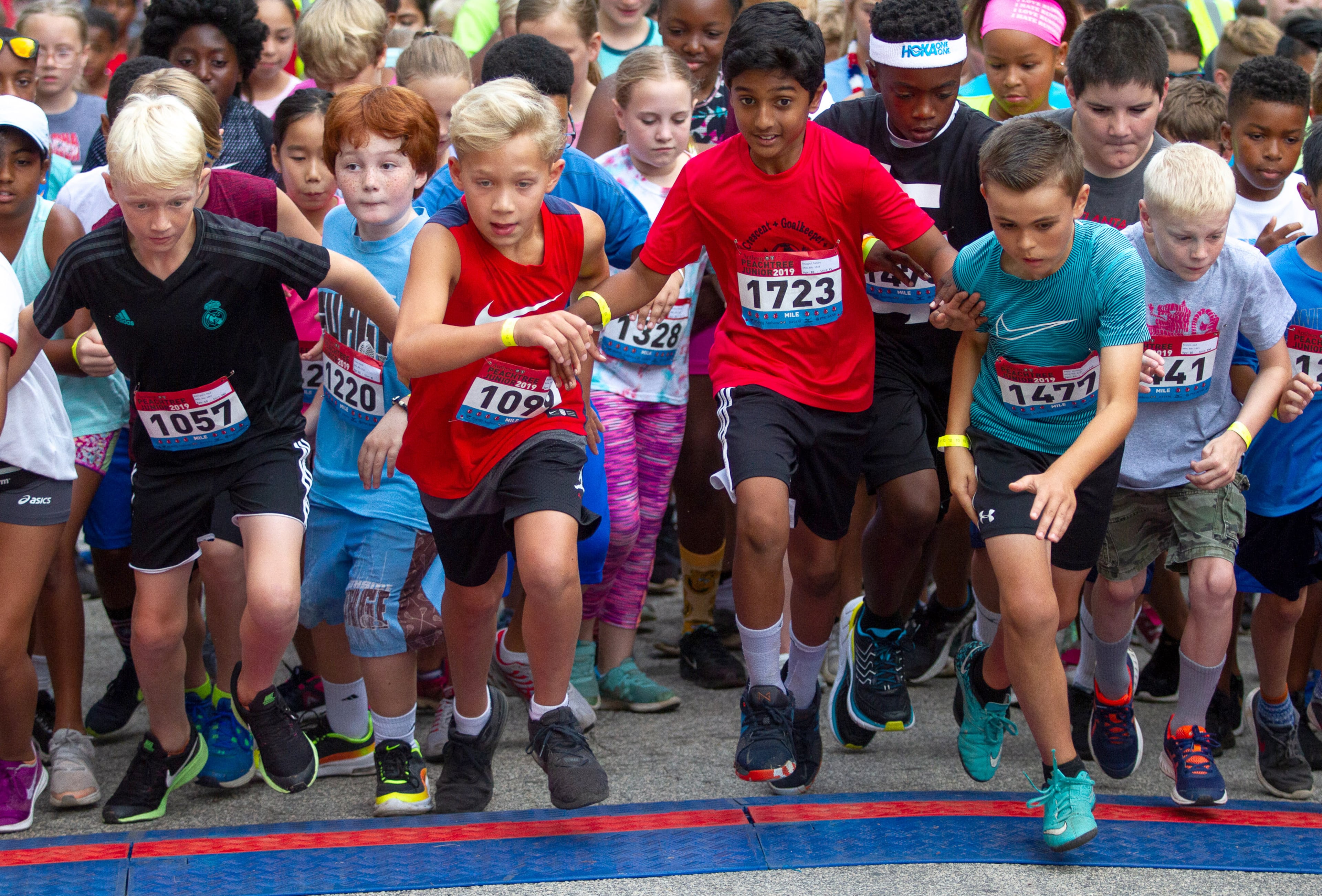 Runners line up on the starting line before the beginning of the one-mile run during The Anthem Peachtree Junior race in Piedmont Park Wednesday, July 3, 2019. STEVE SCHAEFER / SPECIAL TO THE AJC