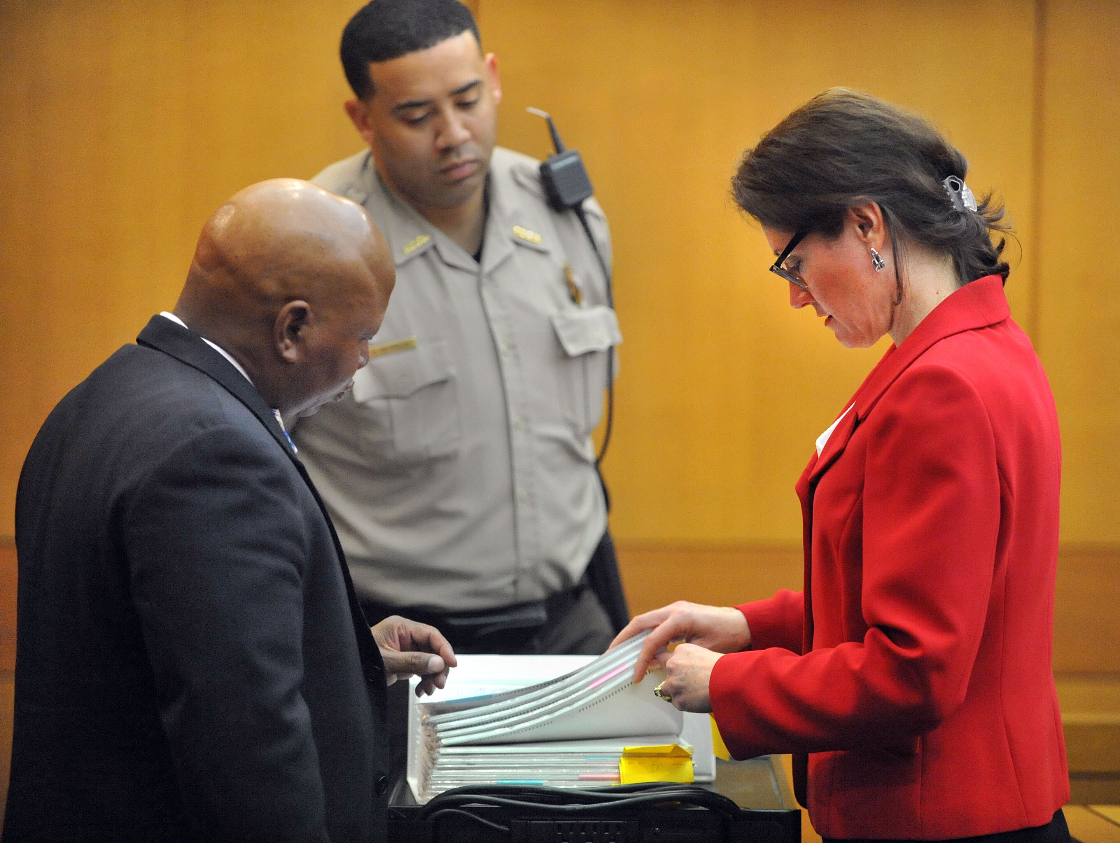 Under the watchful eyes of the bailiff, Fulton County Deputy District Attorney Linda Dunikoski and defense attorney Kevin Franks go through Criterion-Referenced Competency Test score binders that will be sent to the jury Monday afternoon. Franks represents former Dunbar Elementary teacher Diane Buckner-Webb. (Atlanta Journal-Constitution, Kent D. Johnson, Pool)