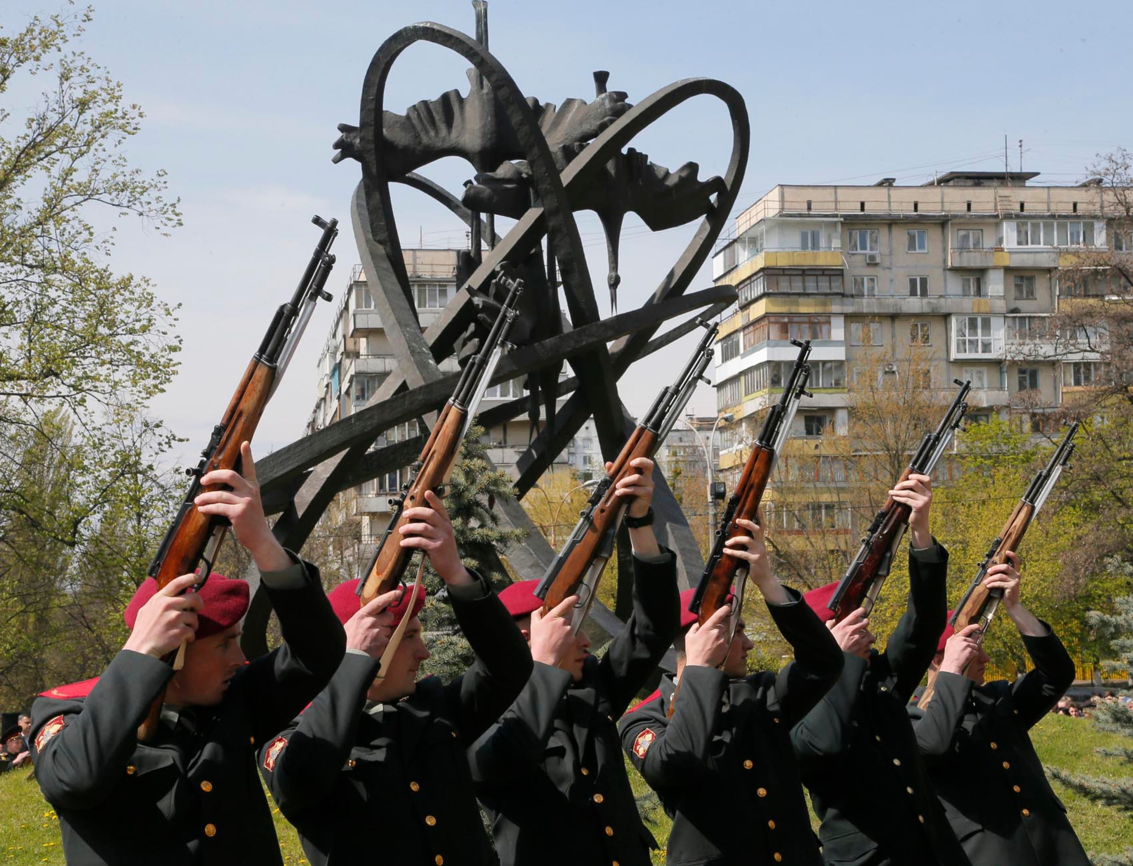 Ukrainian honour guards stand to attention near the monument erected in memory of the victims of the Chernobyl explosion in Ukraine's capital Kiev, Ukraine, Wednesday, April 26, 2017. April 26 marks the 31st anniversary of the Chernobyl nuclear disaster. A reactor at the Chernobyl nuclear power plant exploded on April 26, 1986, leading to an explosion and the subsequent fire spewed a radioactive plume over much of northern Europe. (AP Photo/Efrem Lukatsky)
