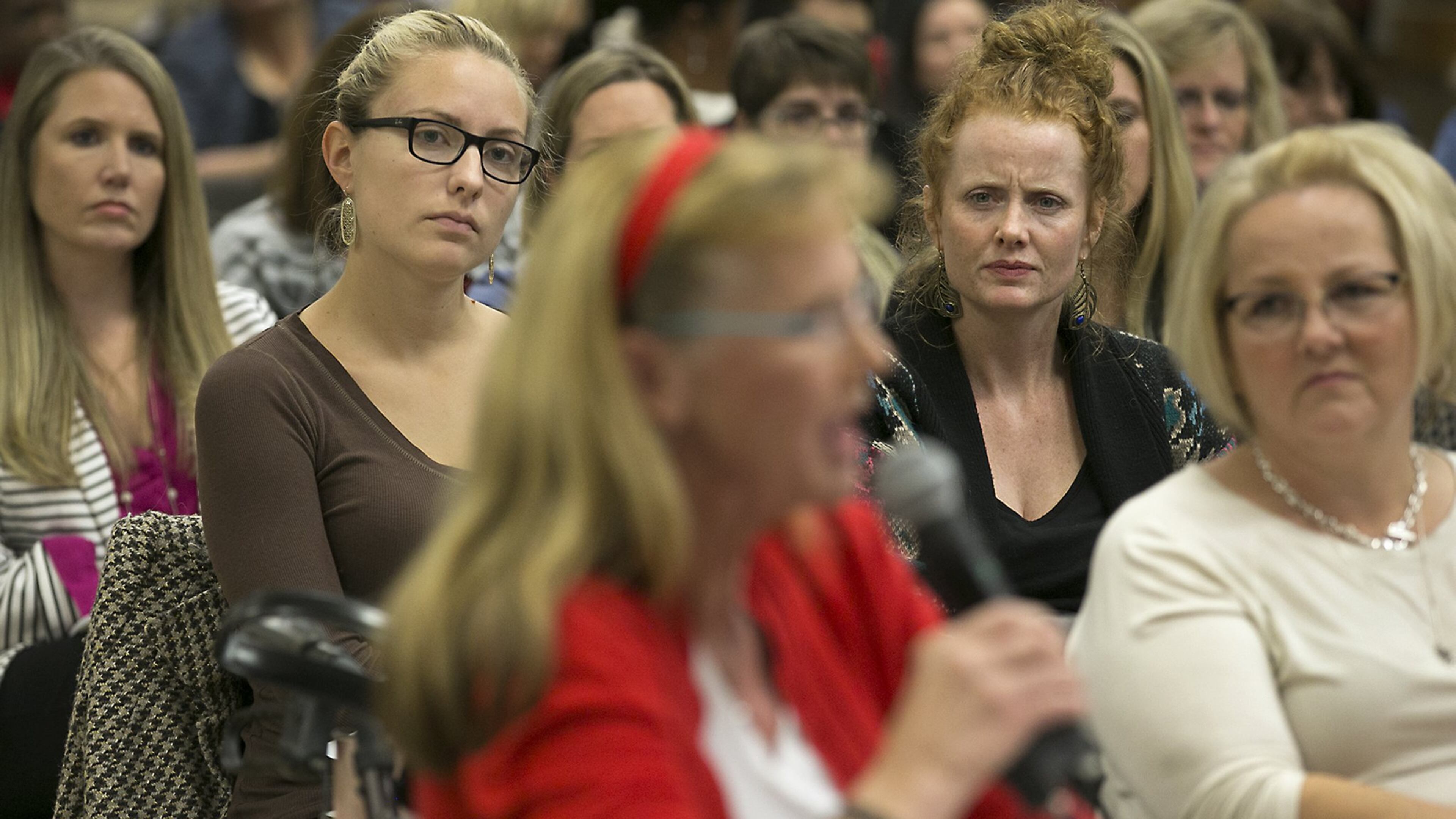 Special education teachers Alyssa Potasznik, left, from the Austin school district, and Emily Miller-Pena, right, from the Lago Vista district, listen intently to Judy Wells, foreground in red, during a 2016 meeting about special education in Texas. A large crowd gathered at the Region 13 Education Service Center in East Austin to voice their displeasure with Texas special education services to a listening board of representatives from the U.S. Department of Education and the Texas Education Agency. RALPH BARRERA / AMERICAN-STATESMAN