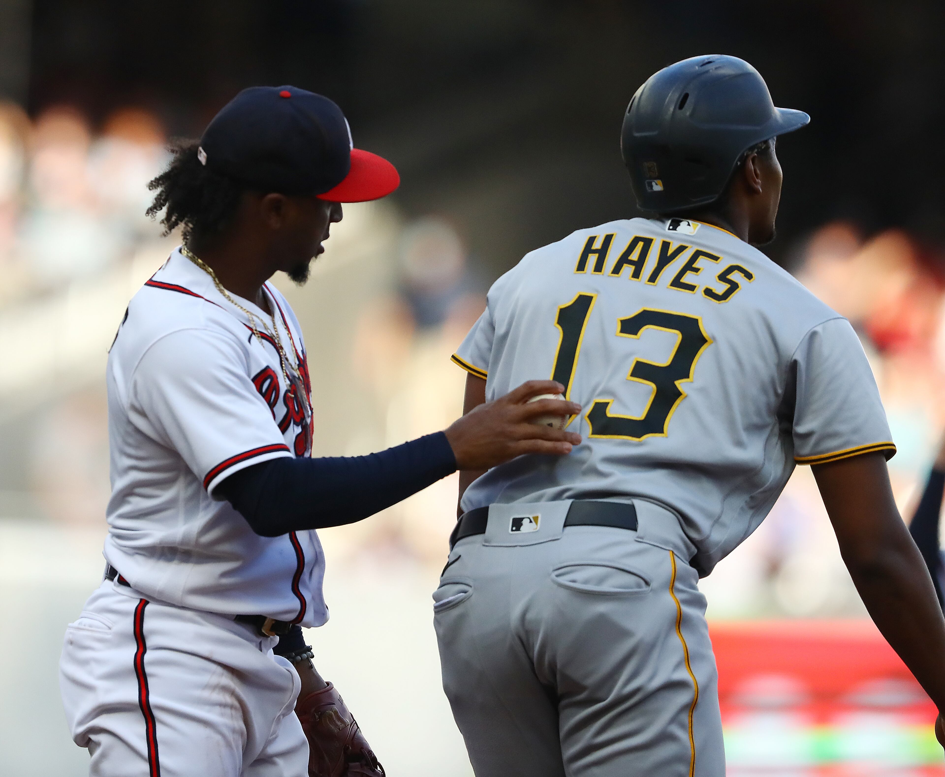 Pittsburgh Pirates Ke'Bryan Hayes is tagged out in a run down by Atlanta Braves second baseman Ozzie Albies during the first inning in a MLB baseball game on Thursday, June 9, 2022, in Atlanta. (Curtis Compton / Curtis.Compton@ajc.com)