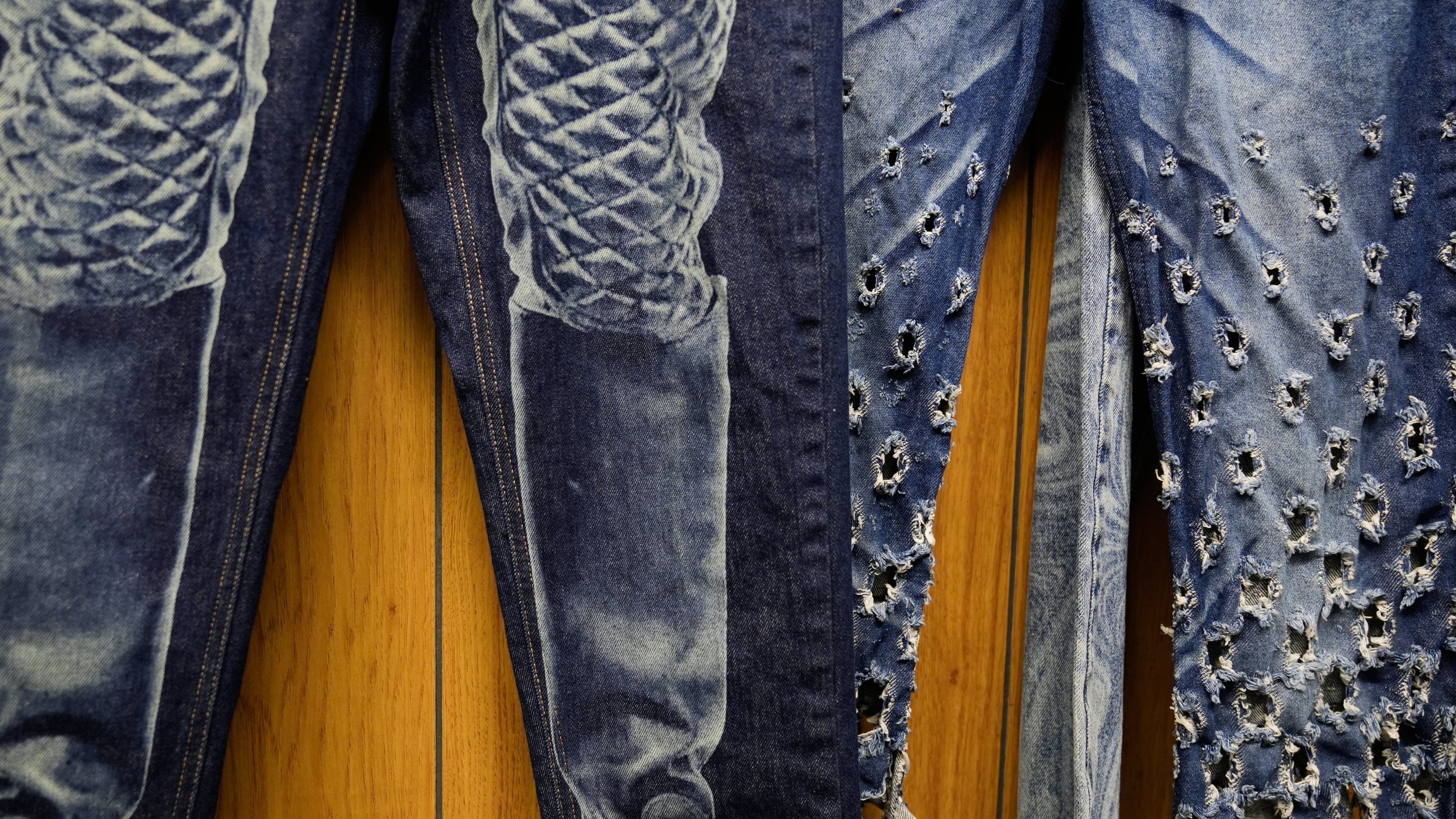 Patterns and distressing, made by a laser, are displayed at the BPD Washhouse, a denim processing facility, in Jersey City, N.J., Tuesday, May 5, 2026. (AP Photo/Seth Wenig)