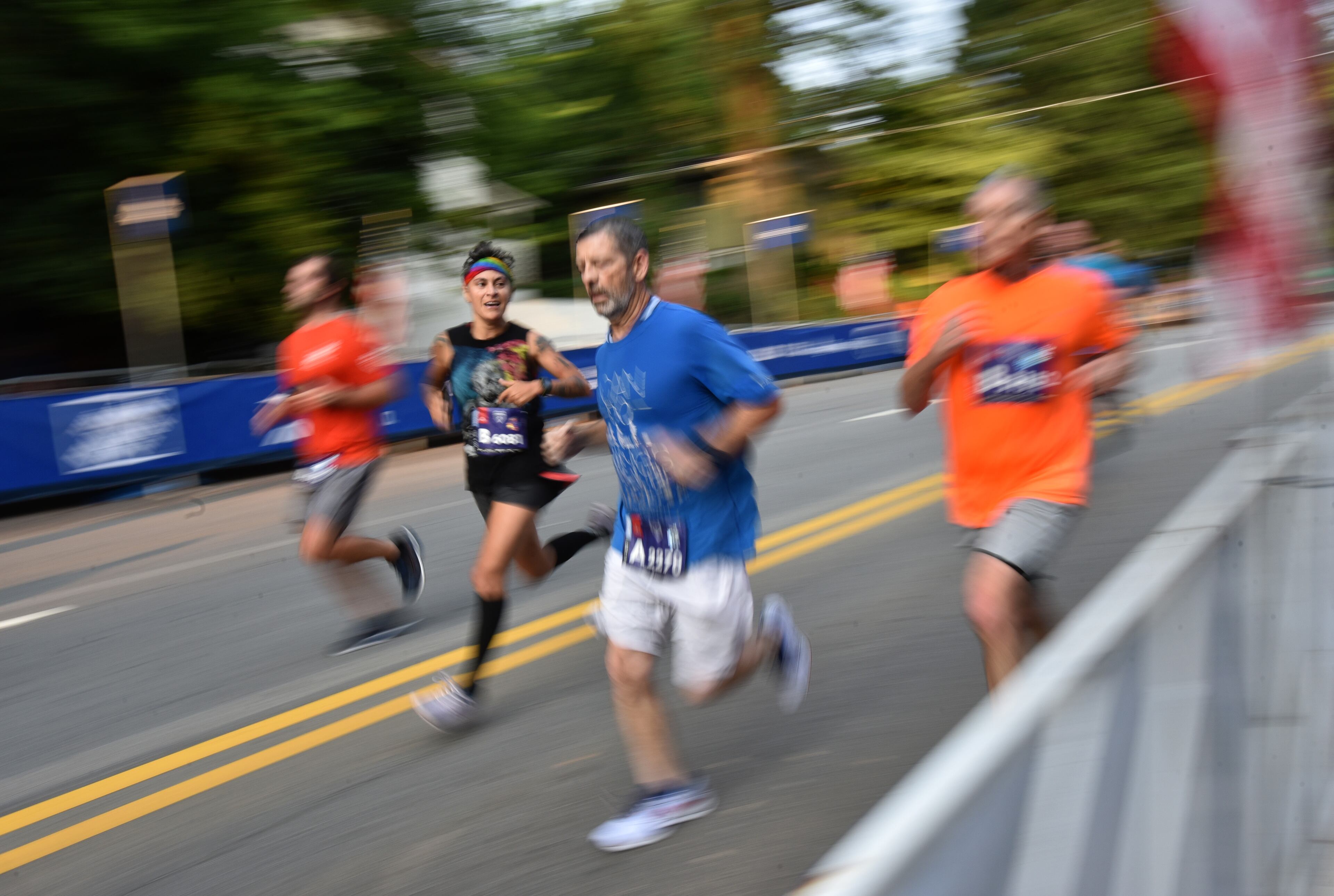 July 3, 2021 Atlanta - Runners make their way down 10th Street by Piedmont Park during the first day of 2021 Atlanta Journal-Constitution Peachtree Road Race on Saturday, July 3, 2021. (Hyosub Shin / Hyosub.Shin@ajc.com)