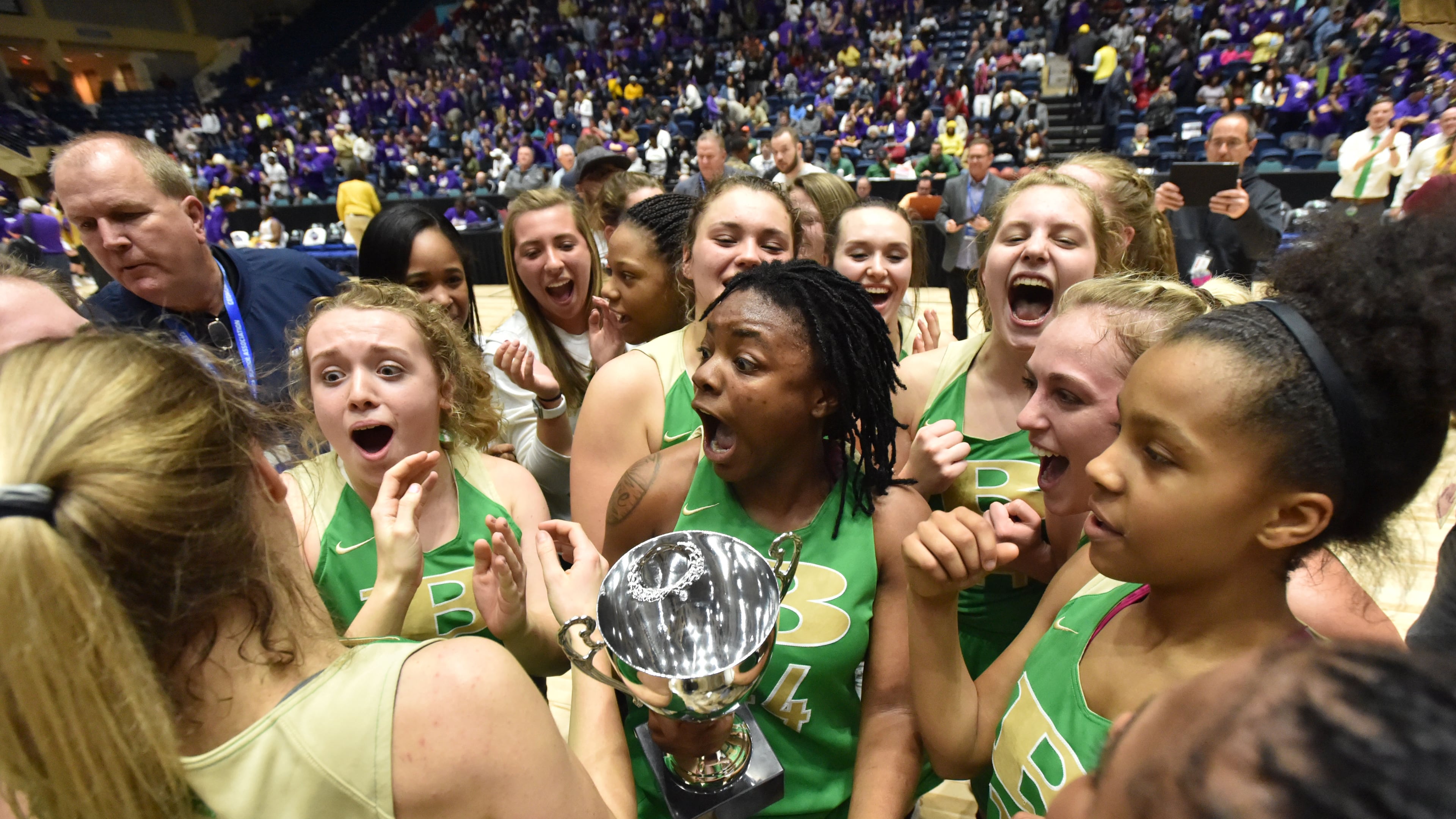 The Buford girls basketball team (pictured) celebrates its 2019 state championship, matching the Wolves' feat in boys basketball that year. The school also won the boys and girls titles in 2017. (Hyosub Shin/AJC)