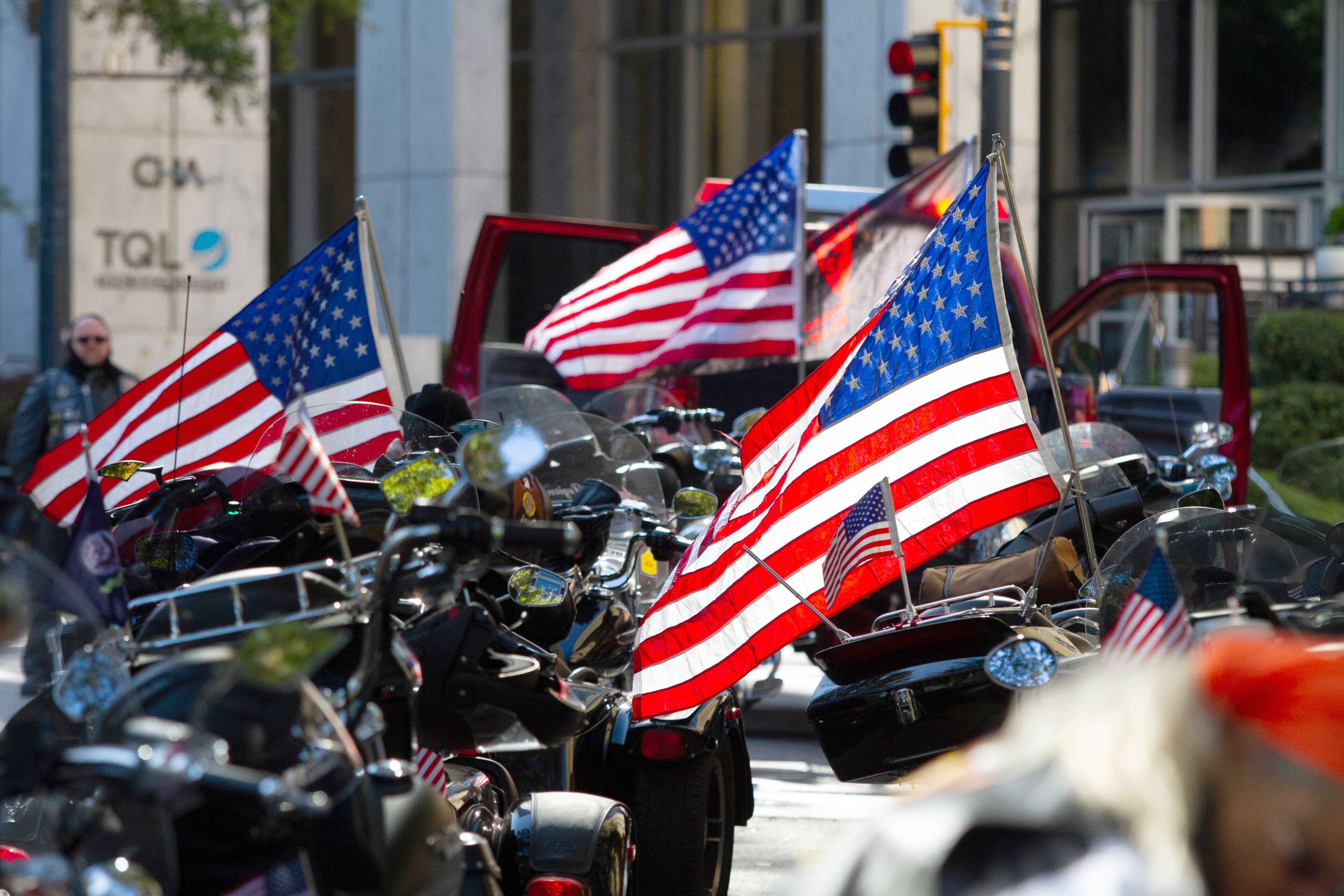 Motorcycles and American flags are lined up on Peachtree Street waiting for the start of the 38th annual Atlanta Veterans Day Parade on Saturday, November 9, 2019. STEVE SCHAEFER / SPECIAL TO THE AJC