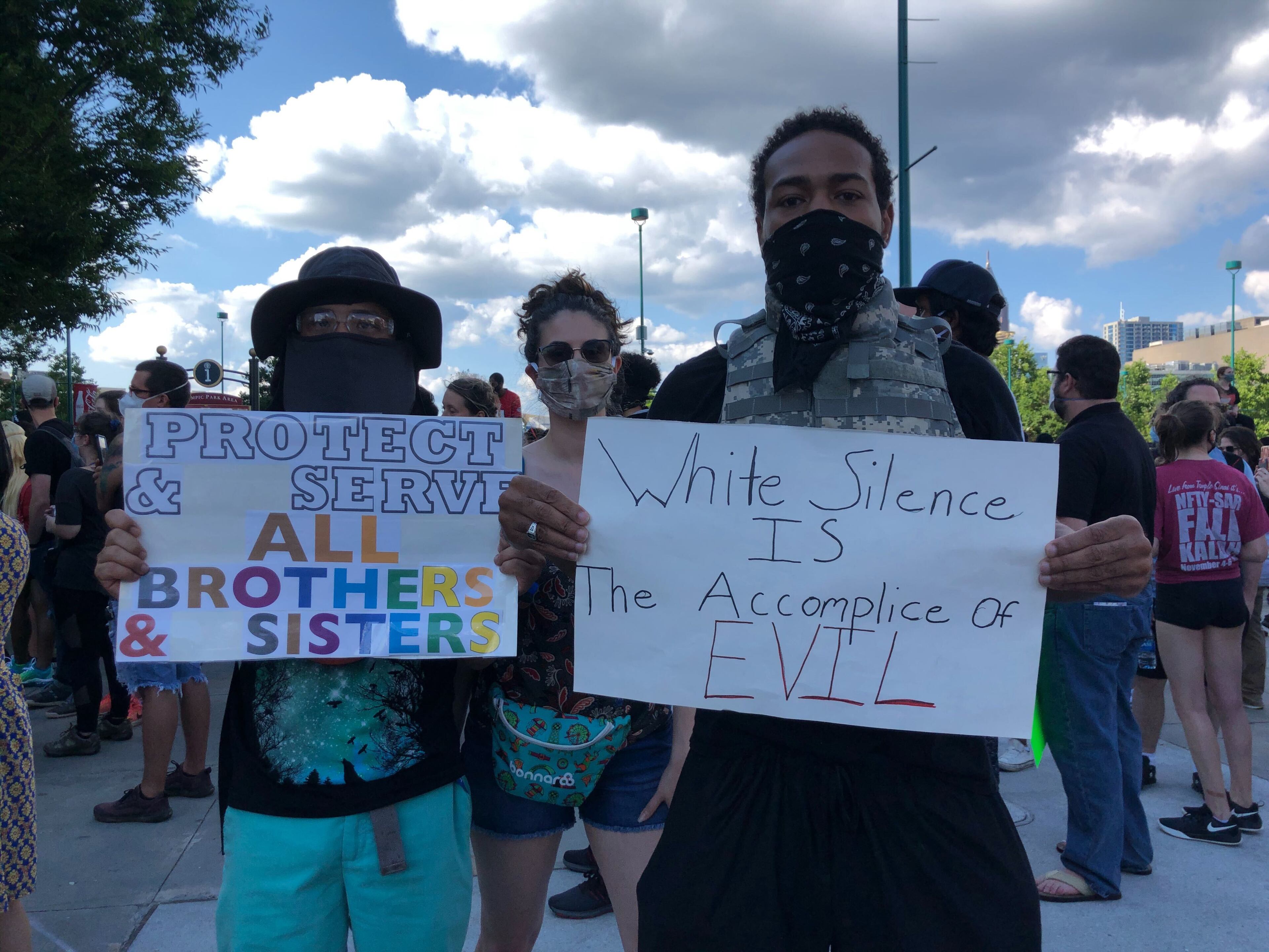 Saturday, May 30 -- Jeremiah Long (left) and Brandon Bell of Atlanta joined more than 200 protesters outside Centennial Olympic Park before 6 p.m. AJC Photo: David Wickert