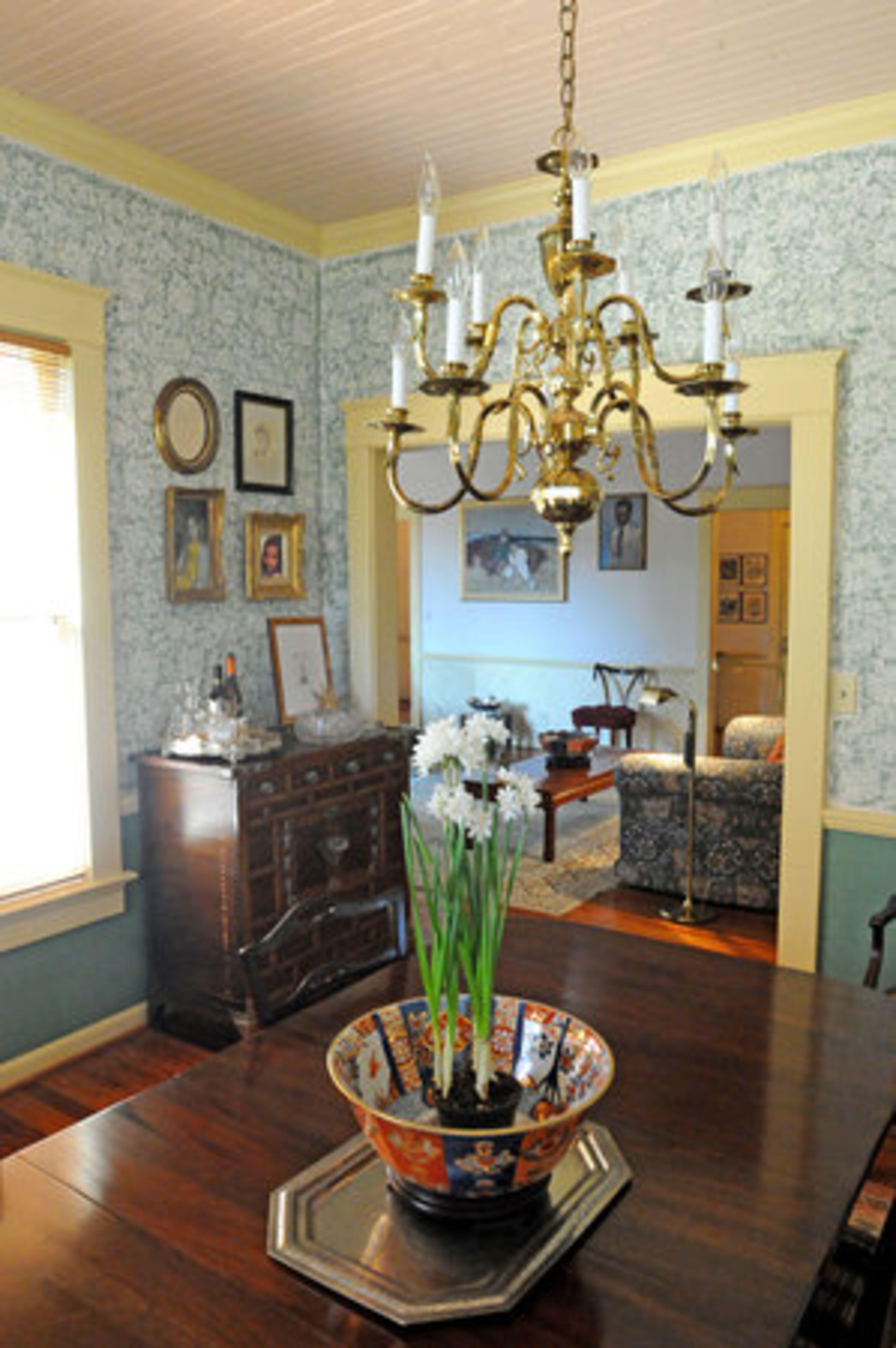 Wanda used stencils to hand paint the walls of the formal dining room. French and Polish lithographs are showcased in this room.