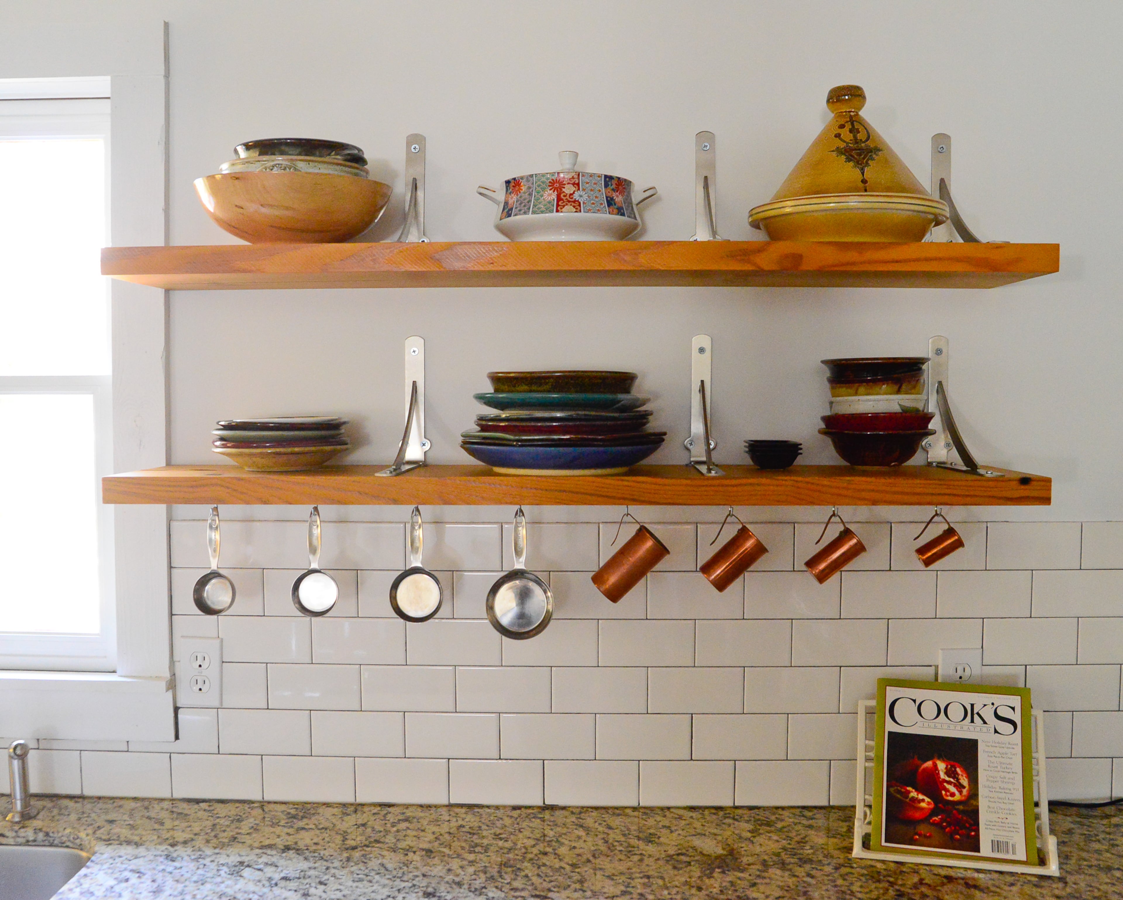 Homeowners Eileen Ansley and Andrew Burnes removed the upper cabinets from their 1927 bungalow and replaced them with heart pine shelves made by Athens carpenter Noah Brendel (piedmontbureauofreclamation.com).