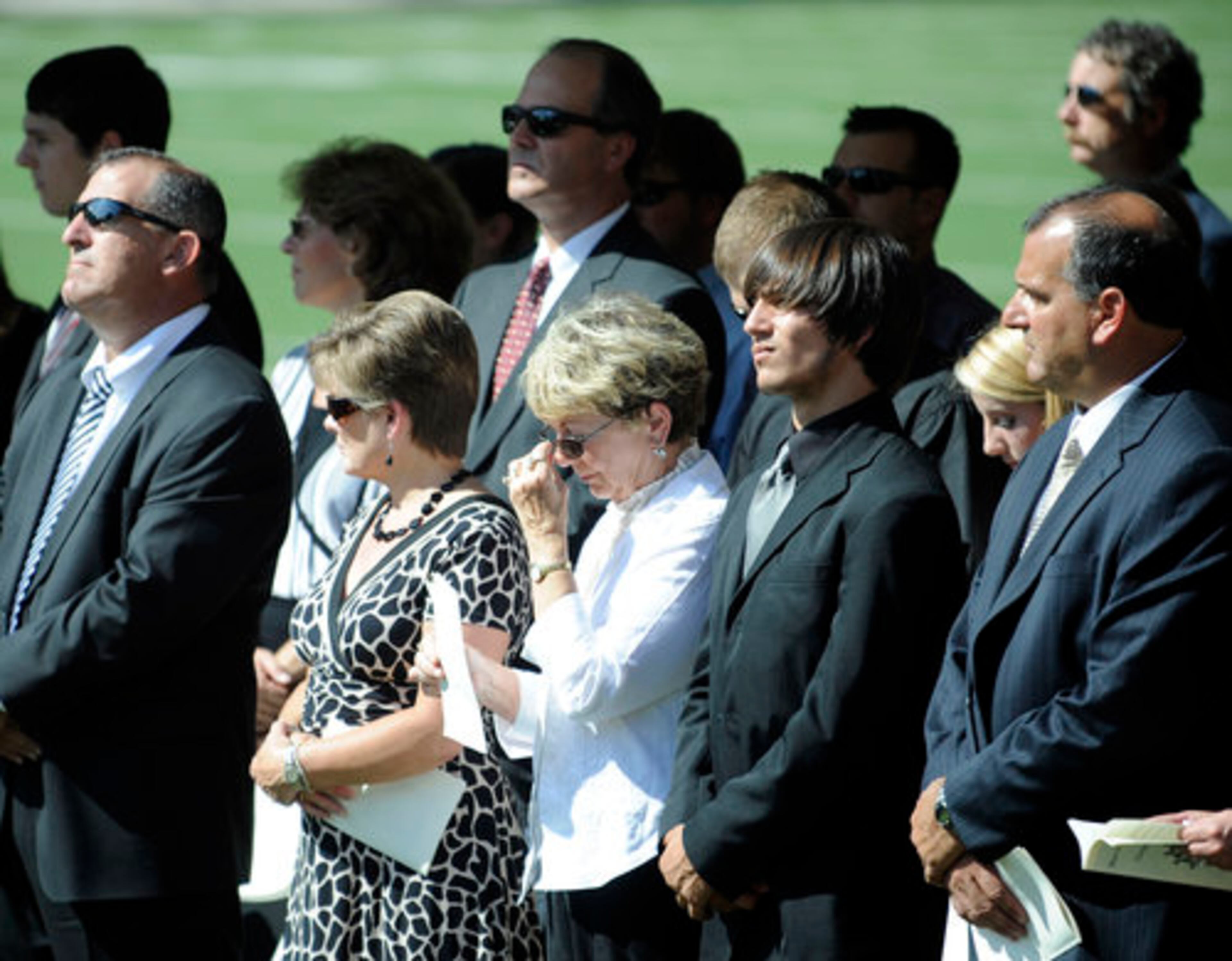 Maloof's family members, including widow Anita Maloof (center, white shirt) and sons Keith Maloof (far right) and Kevin Maloof (far left, sunglasses) pay their respects. Keith Maloof is the head football coach at Norcross High School. Kevin Maloof is the head football coach and athletic director at Dacula High School.