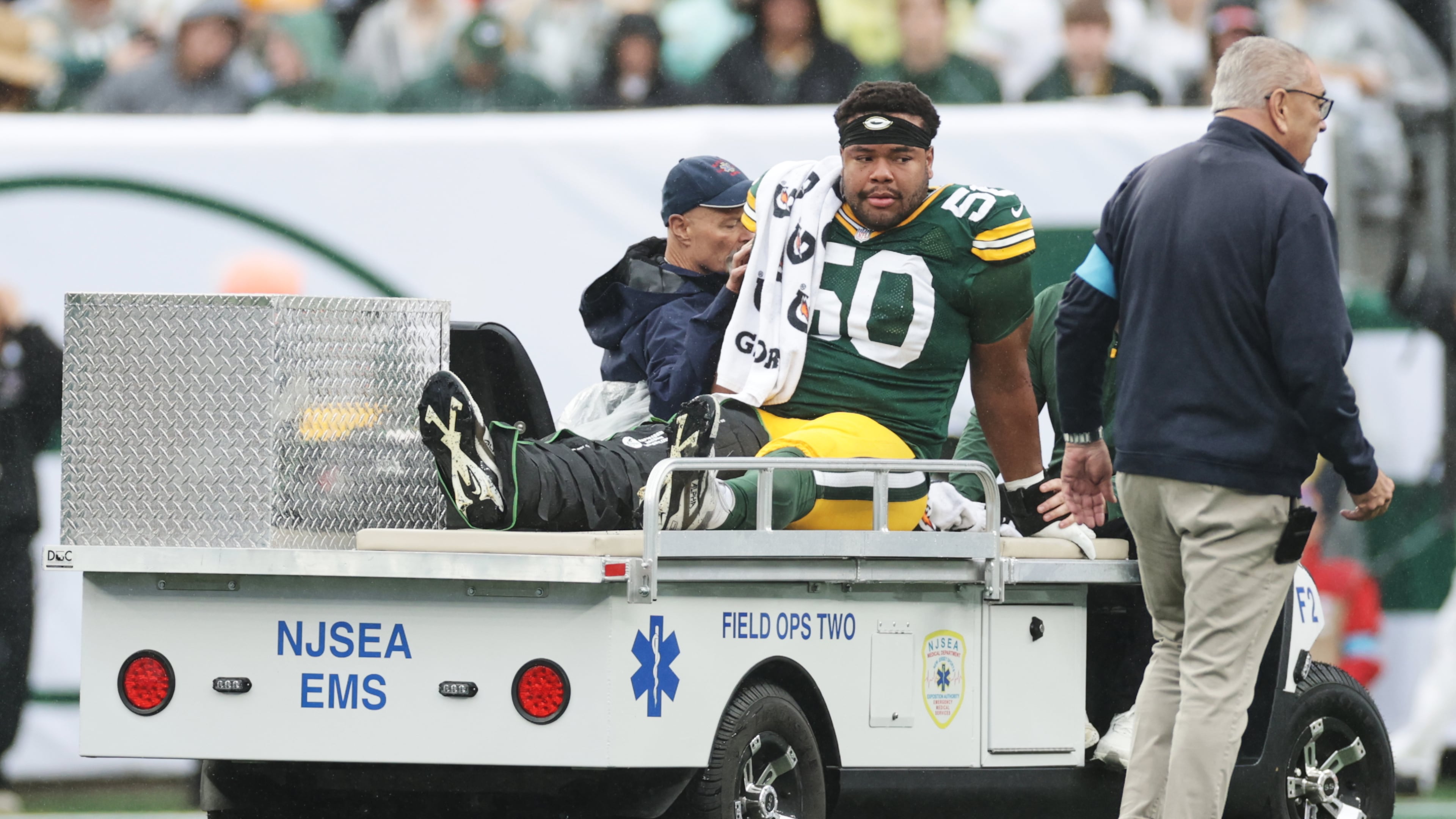 Green Bay Packers guard Zach Bako-Bewele (50) is taken off the field following an injury during an NFL football game against the New York Jets in East Rutherford, N.J., Sunday, Sept. 20, 2026. (AP Photo/Adam Hunger)