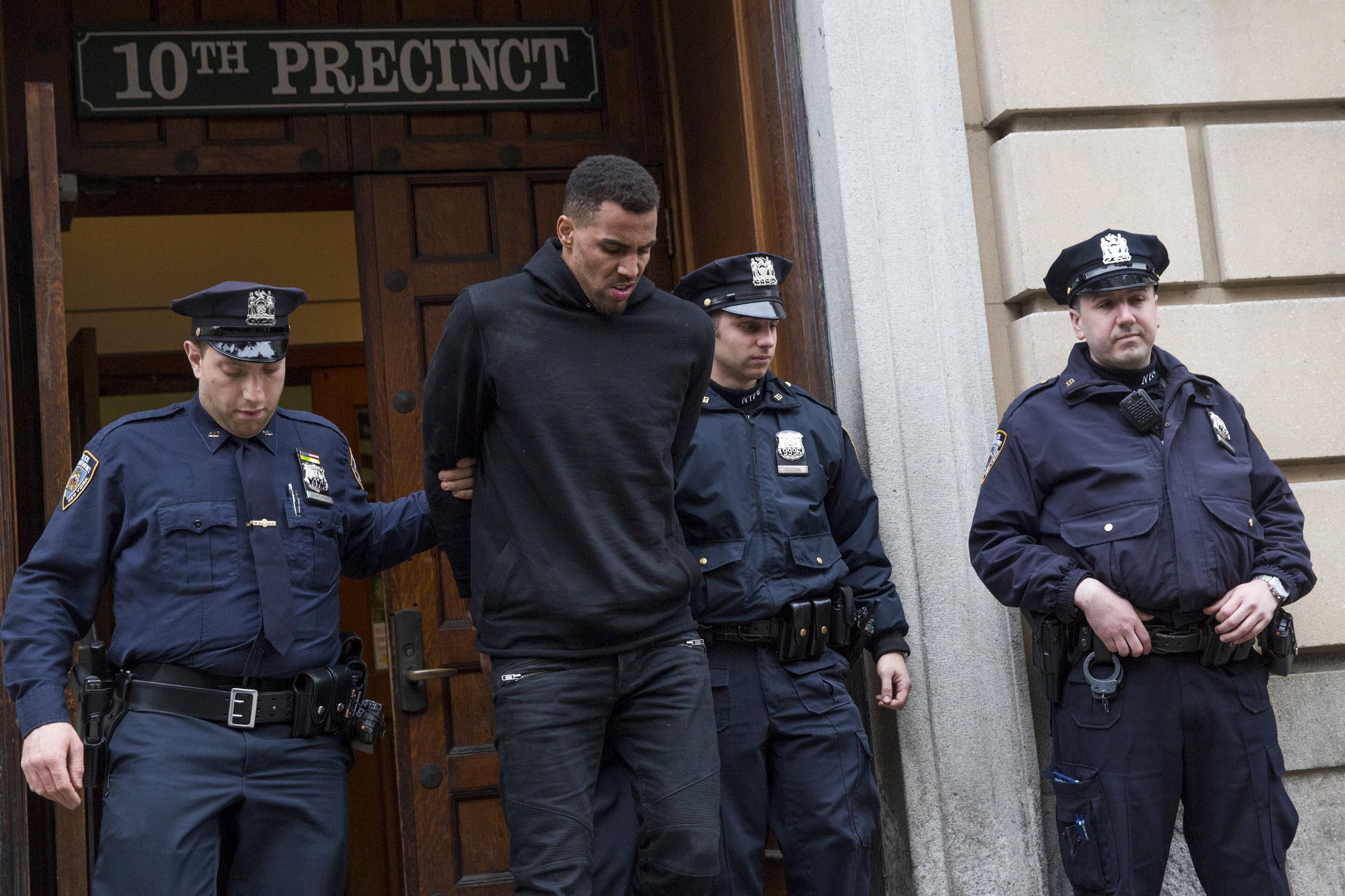NBA player Thabo Sefolosha, 30, of the Atlanta Hawks is seen escorted out of the 10th Precinct of the New York Police Department (NYPD) in Manhattan, New York on April 8, 2015. NBA player Chris Copeland of the Indiana Pacers and his wife were stabbed during a dispute outside a New York City nightclub early on Wednesday and hospitalized with non-life-threatening injuries, according to police and media reports. Two Atlanta Hawks players were taken into custody for interfering with the arrest and trying to prevent police from setting up a crime scene. Police identified them as Pero Antic, 33, and Thabo Sefolosha, 30, both of Atlanta. REUTERS/Andrew Kelly TPX IMAGES OF THE DAY