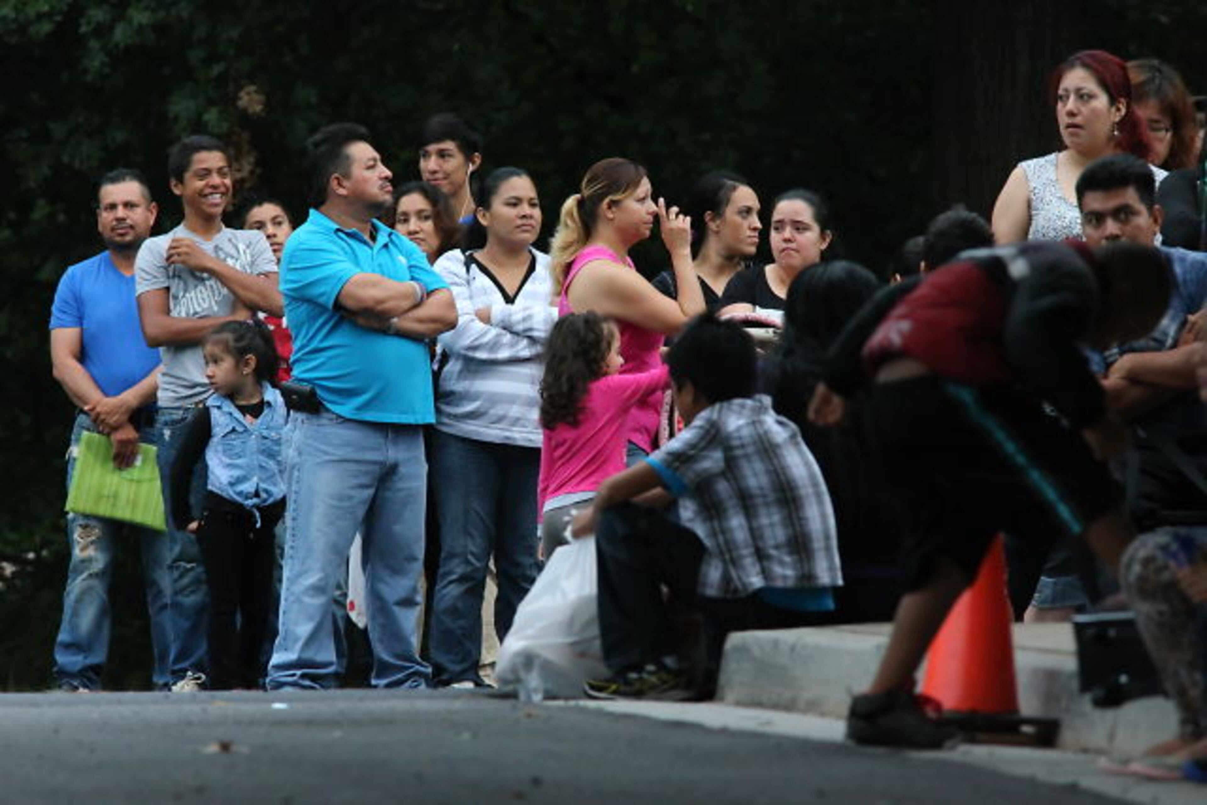Hoping to get their children enrolled in DeKalb County Schools, immigrant families spent Thursday night and early Friday lined up with their children outside district headquarters.