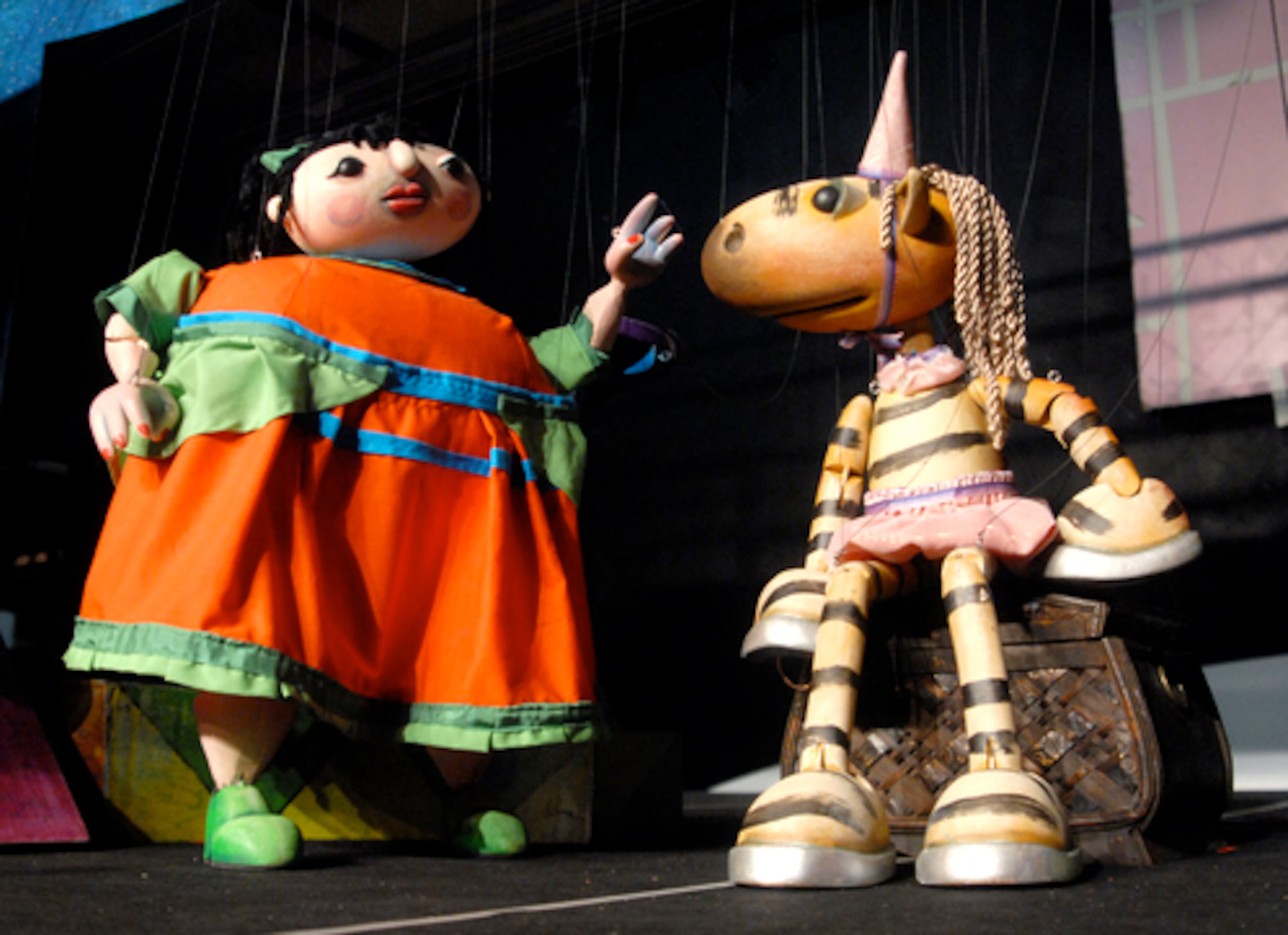 "CORNELIA ZEBRACORN" (right) is a horse painted to look like a zebra. She's accompanied by "Petite Bullie."
