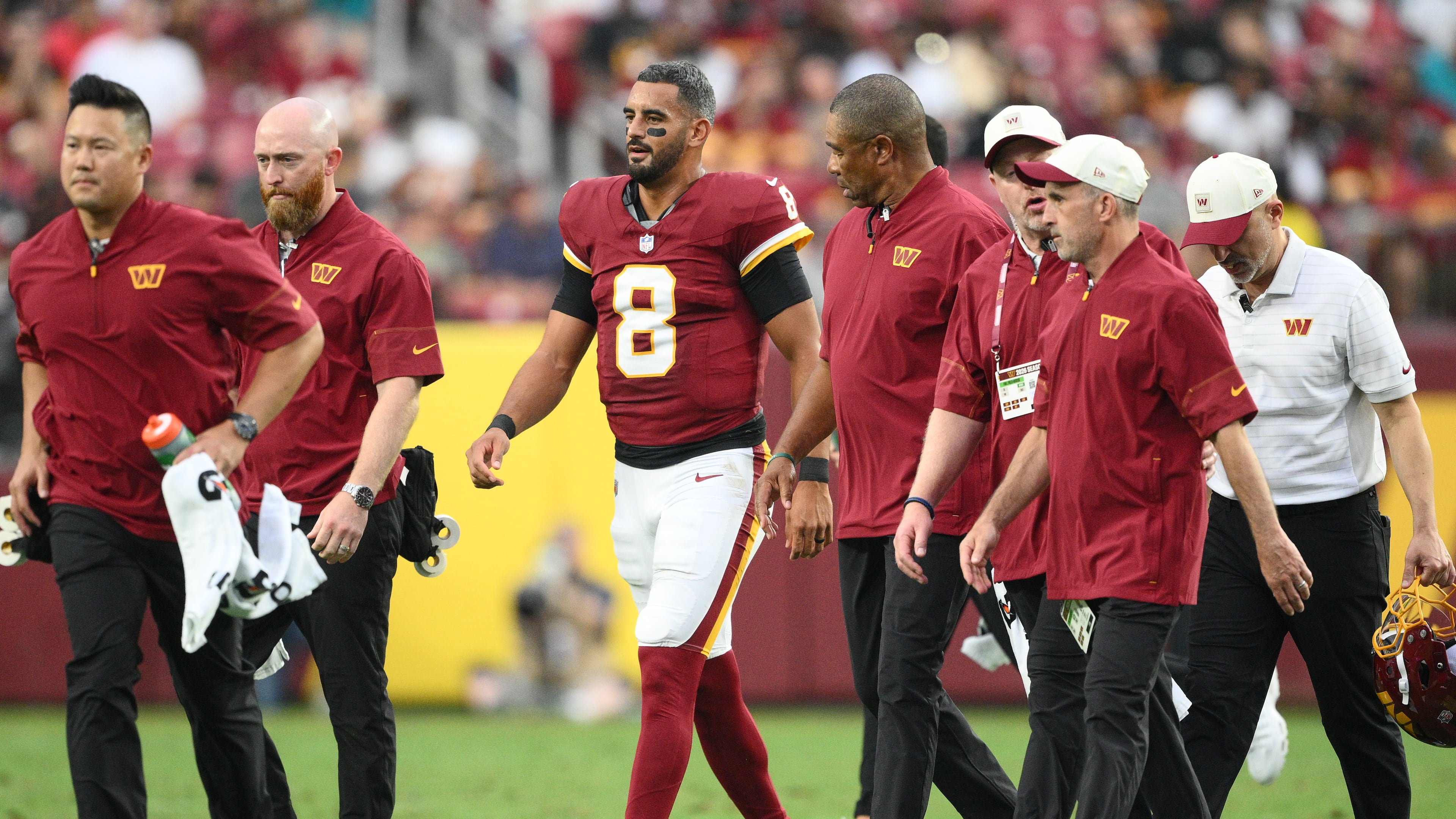 Washington Commanders quarterback Marcus Mariota (8) walks off the field during the first half of an NFL preseason football game against the Miami Dolphins, Friday, Aug. 14, 2026, in Landover, MD. (AP Photo/Nick Wass)