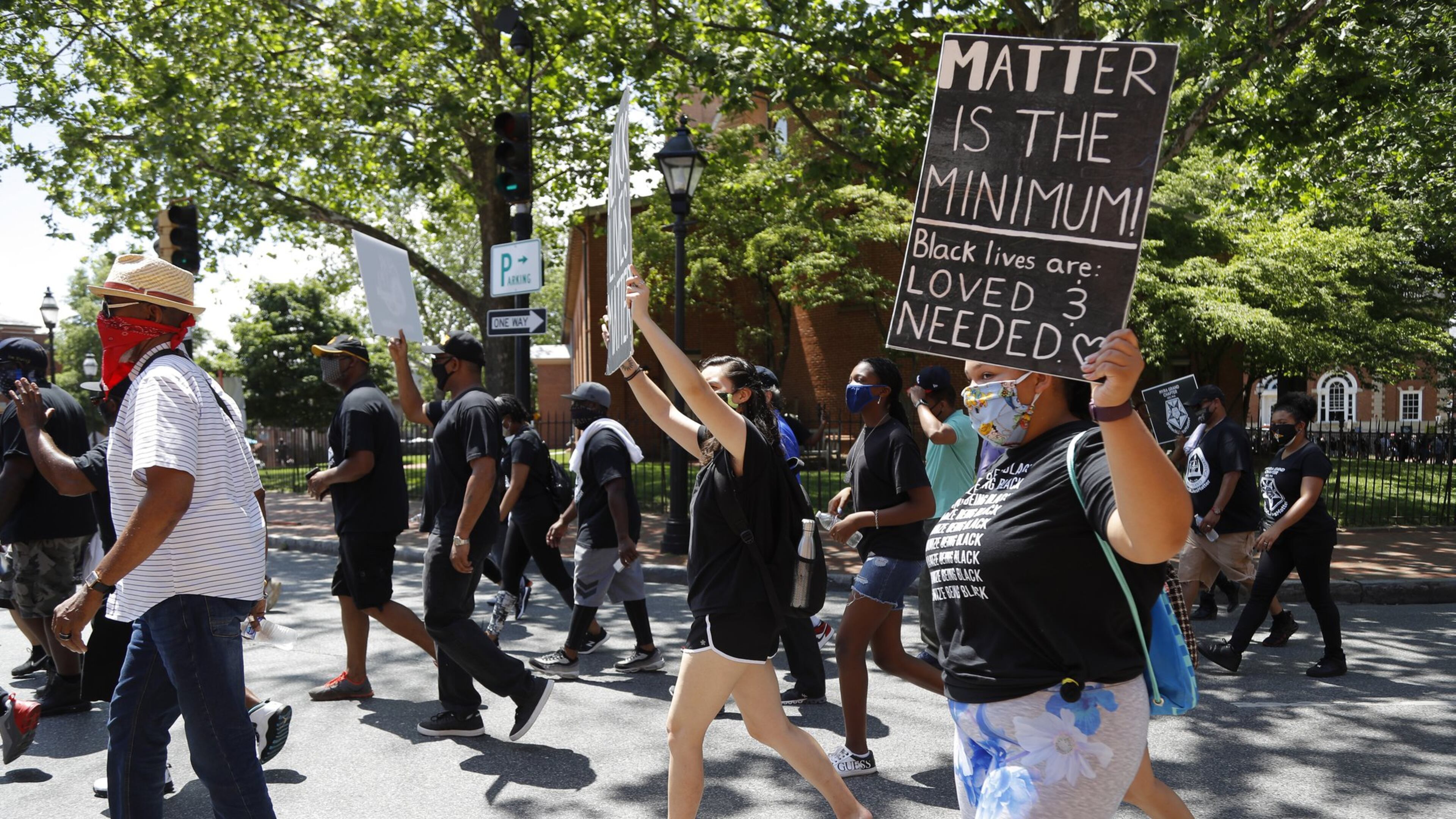 People hold signs while marching through Church Circle, Friday, June 19, 2020 in downtown Annapolis, Md., during Juneteenth 2020 celebration and protest against police brutality. Juneteenth marks the day in 1865 when federal troops arrived in Galveston, Texas, to take control of the state and ensure all enslaved people be freed, more than two years after the Emancipation Proclamation. (AP Photo/Julio Cortez)