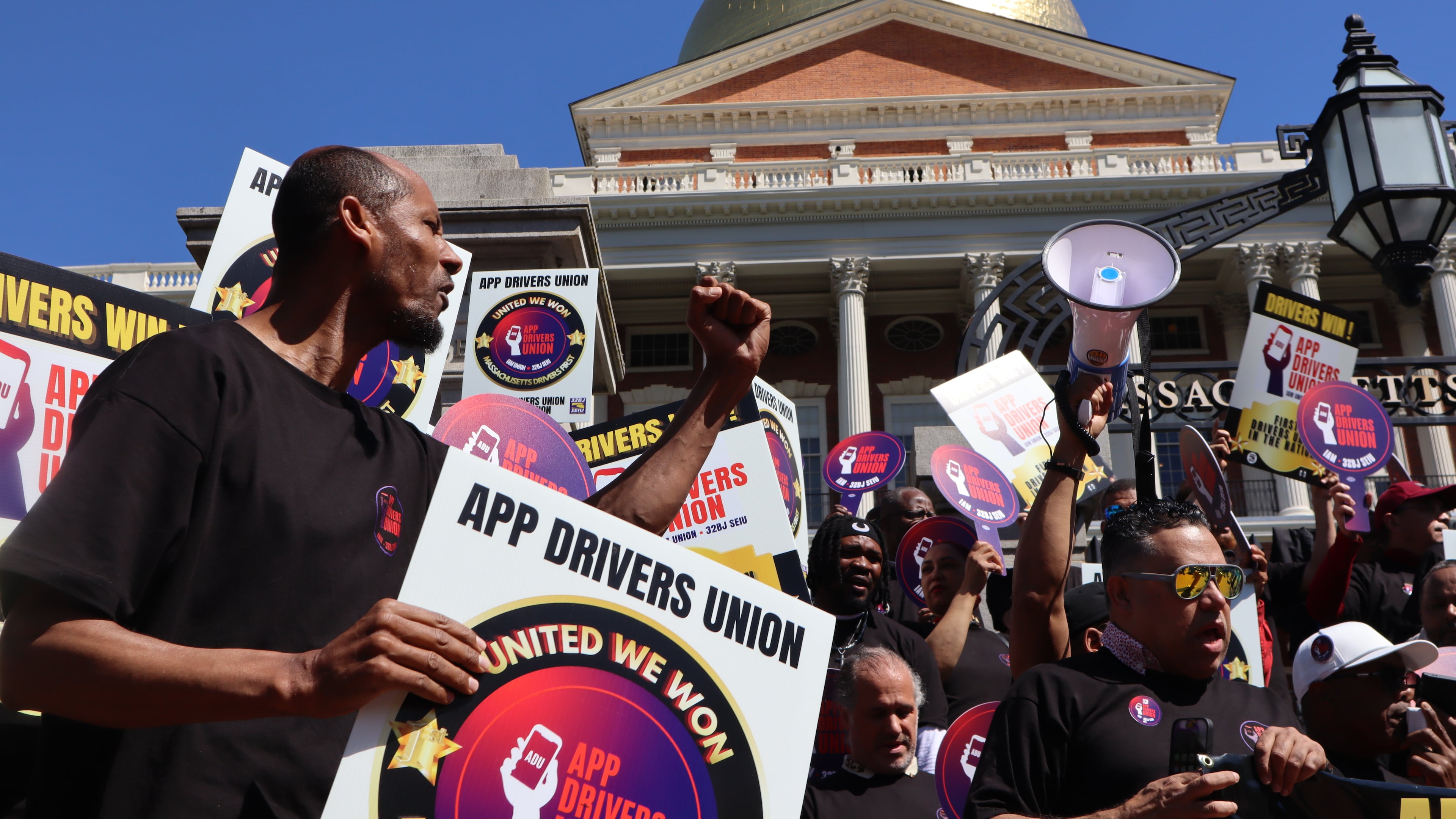 Members of the App Drivers Union hold a rally outside the Massachusetts State House after the announcement that it had become the first certified union of rideshare drivers in the nation, on Tuesday, May 26, 2026, in Boston. (AP Photo/Leah Willingham)