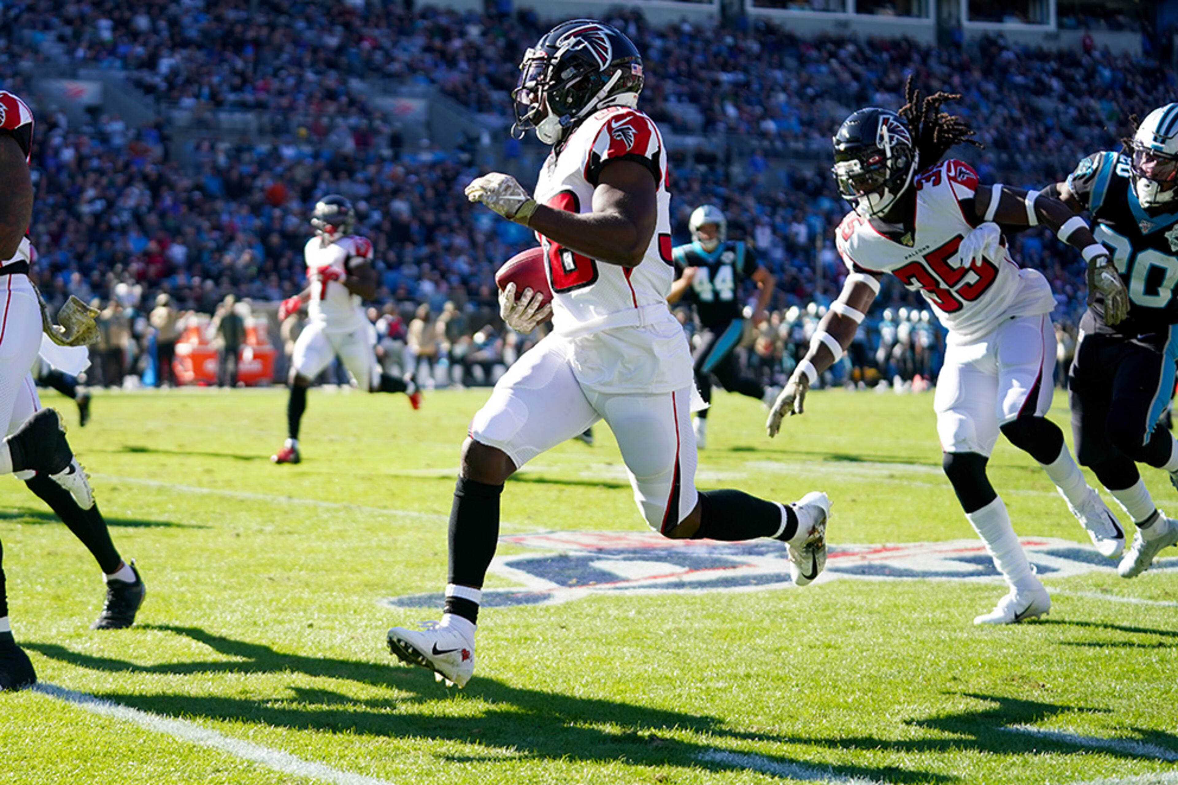 Atlanta's Kenjon Barner returns a punt for a touchdown during the first quarter Sunday, Nov. 19, 2019, at Bank of America Stadium in Charlotte.