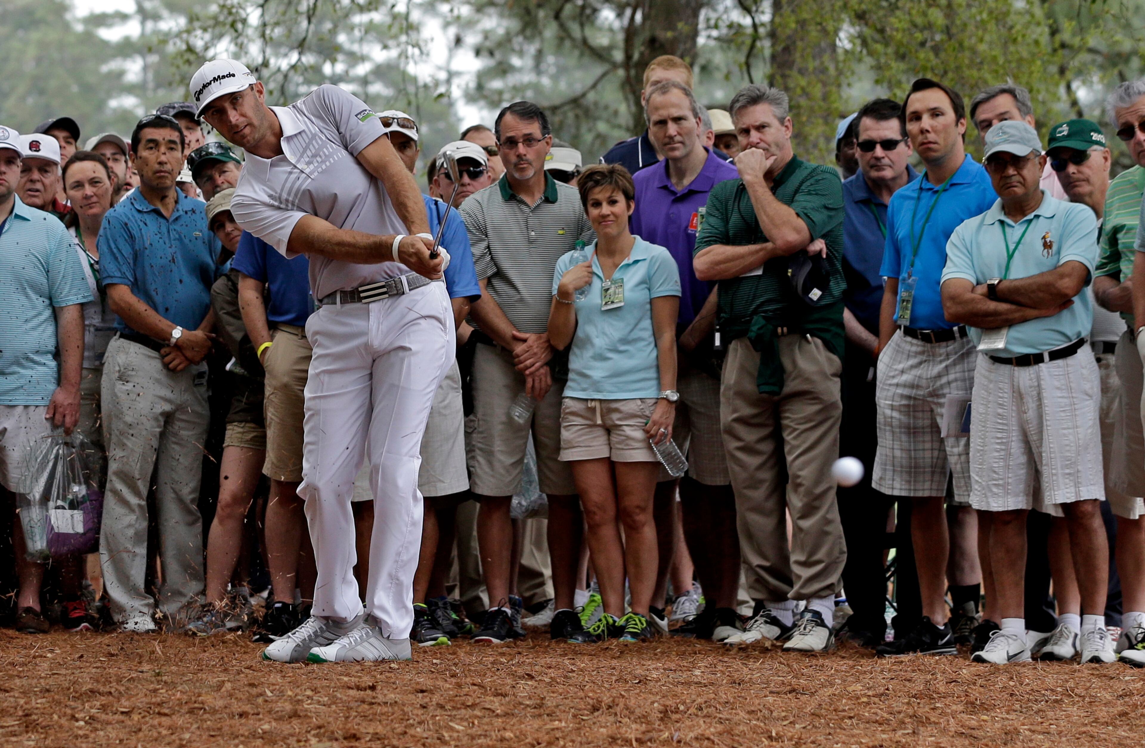 Dustin Johnson takes his second shot on off the rough on the first hole during the second round.