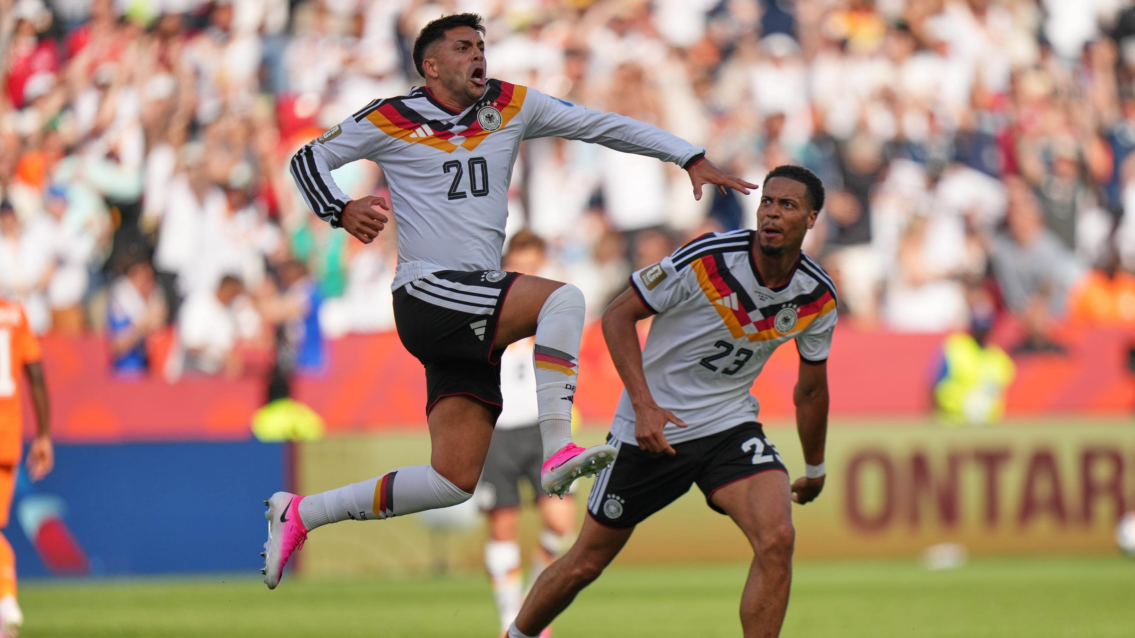 Germany's Nadiem Amiri leaps in the air as he celebrates after teammate Germany's Deniz Undav (26) scored their first goal during the World Cup Group E soccer match between Germany and Ivory Coast in Toronto, Saturday, June 20, 2026. (AP Photo/Stephanie Scarbrough)