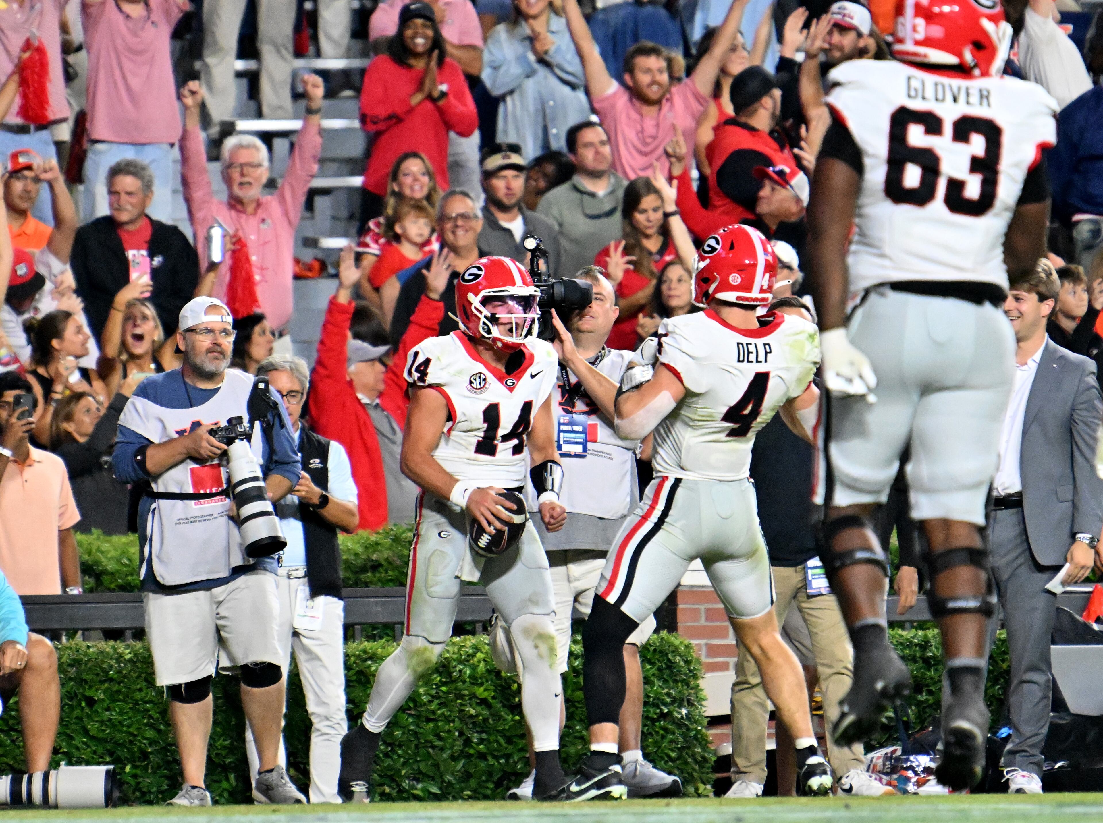 Georgia quarterback Gunner Stockton (14) celebrates after scoring a touchdown during the second half in a NCAA college football game at Jordan-Hare Stadium, Saturday, October 11, 2025, in Auburn, Ala. Georgia won 20-10 overAuburn. (Hyosub Shin / AJC)