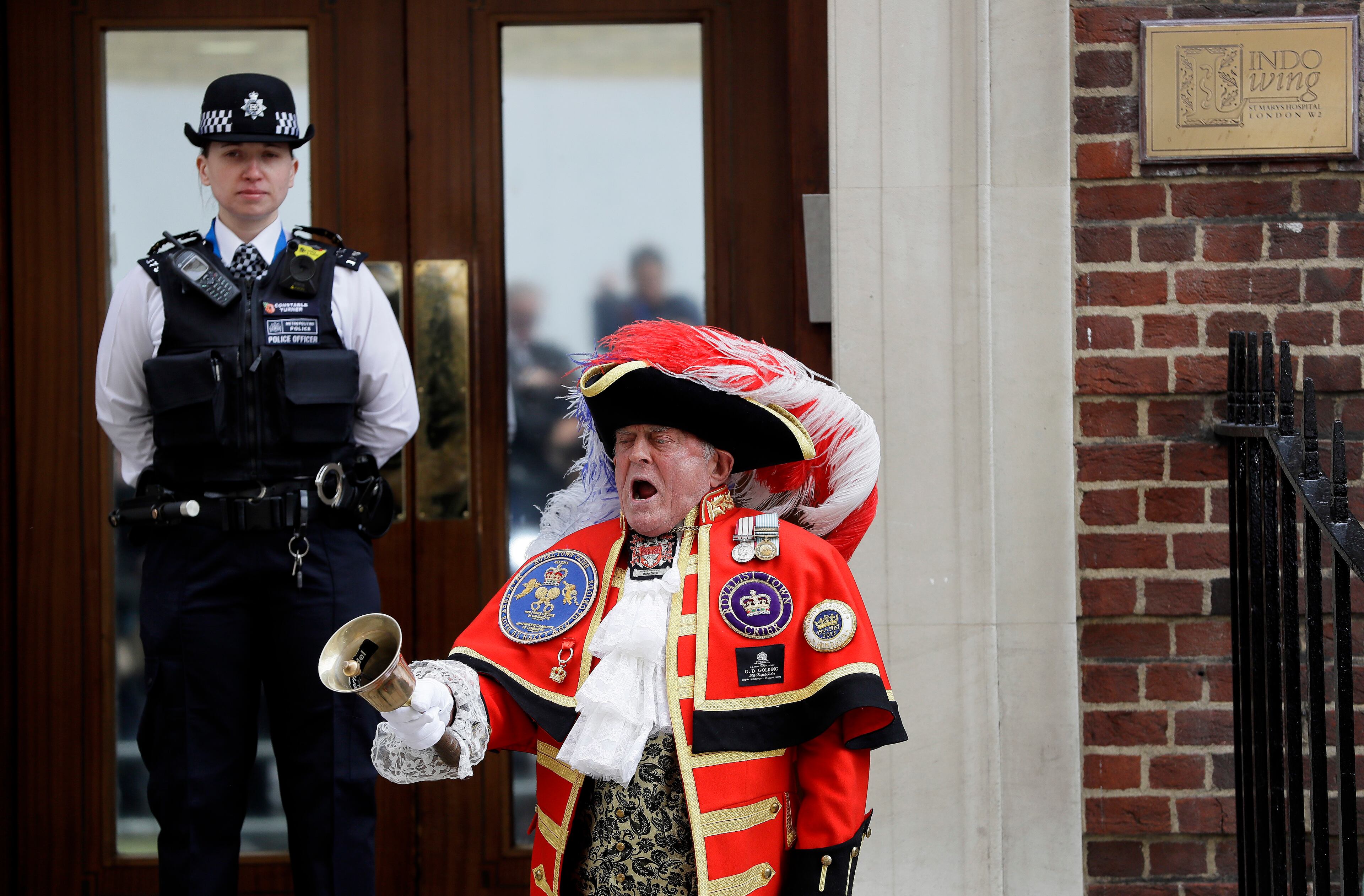 Town Crier Tony Appleton announces that the Duchess of Cambridge has given birth to a baby boy outside the Lindo wing at St Mary's Hospital in London London, Monday, April 23, 2018. Kensington Palace says the Duchess of Cambridge has given birth to her third child, a boy weighing 8 pounds, 7 ounces (3.8 kilograms). (AP Photo/Kirsty Wigglesworth)