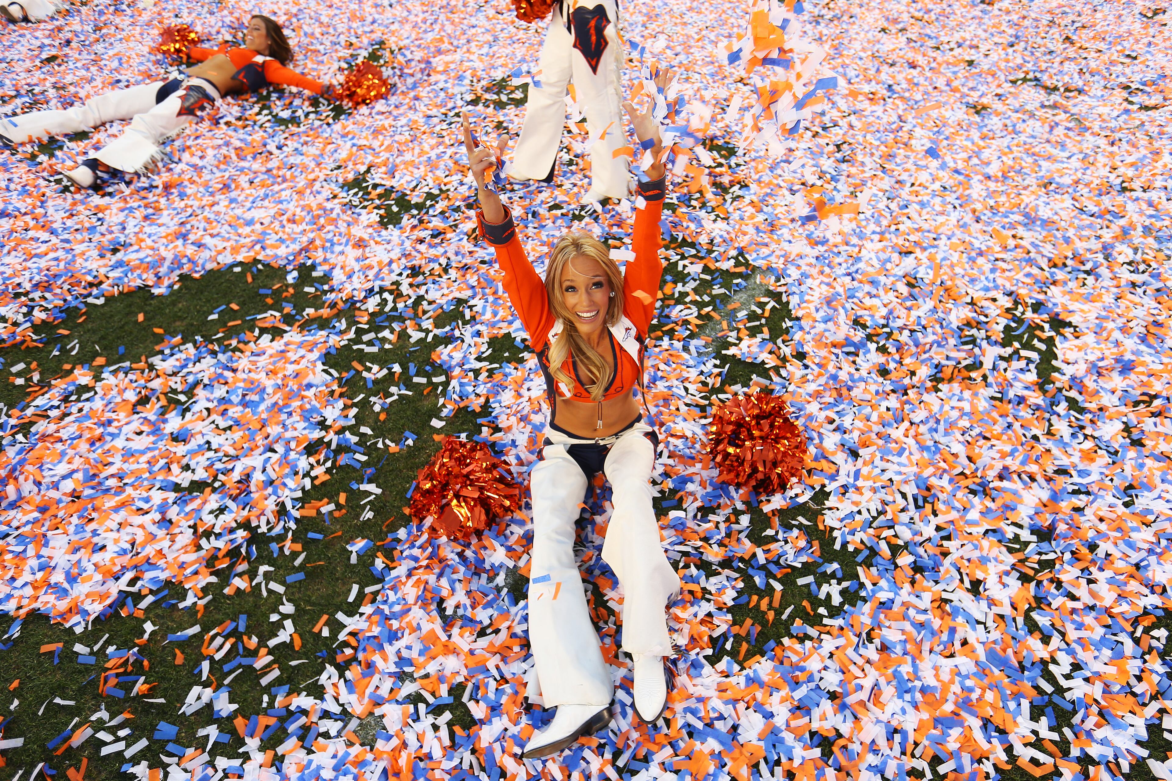 A Denver Broncos cheerleader celebrates after they defeated the New England Patriots 26 to 16 during the AFC Championship game at Sports Authority Field at Mile High on Jan. 19, 2014, in Denver, Colo.