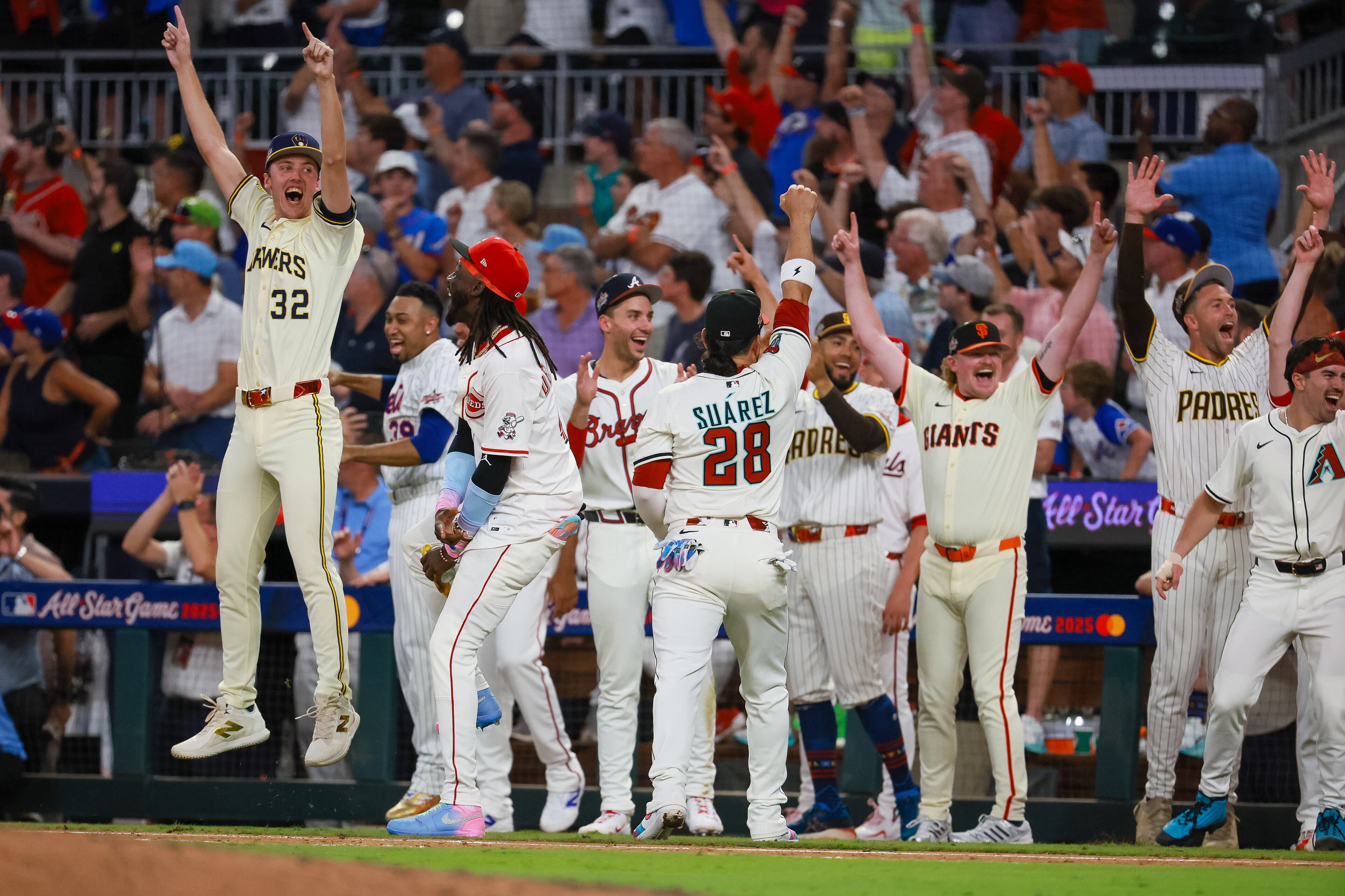 National League players celebrate after designated hitter Kyle Schwarber of the Philadelphia Phillies hit a homer to win the MLB All-Star Game in a swing-off against the American League at Truist Park on Tuesday, July 15, 2025, in Atlanta. (Jason Getz/AJC)