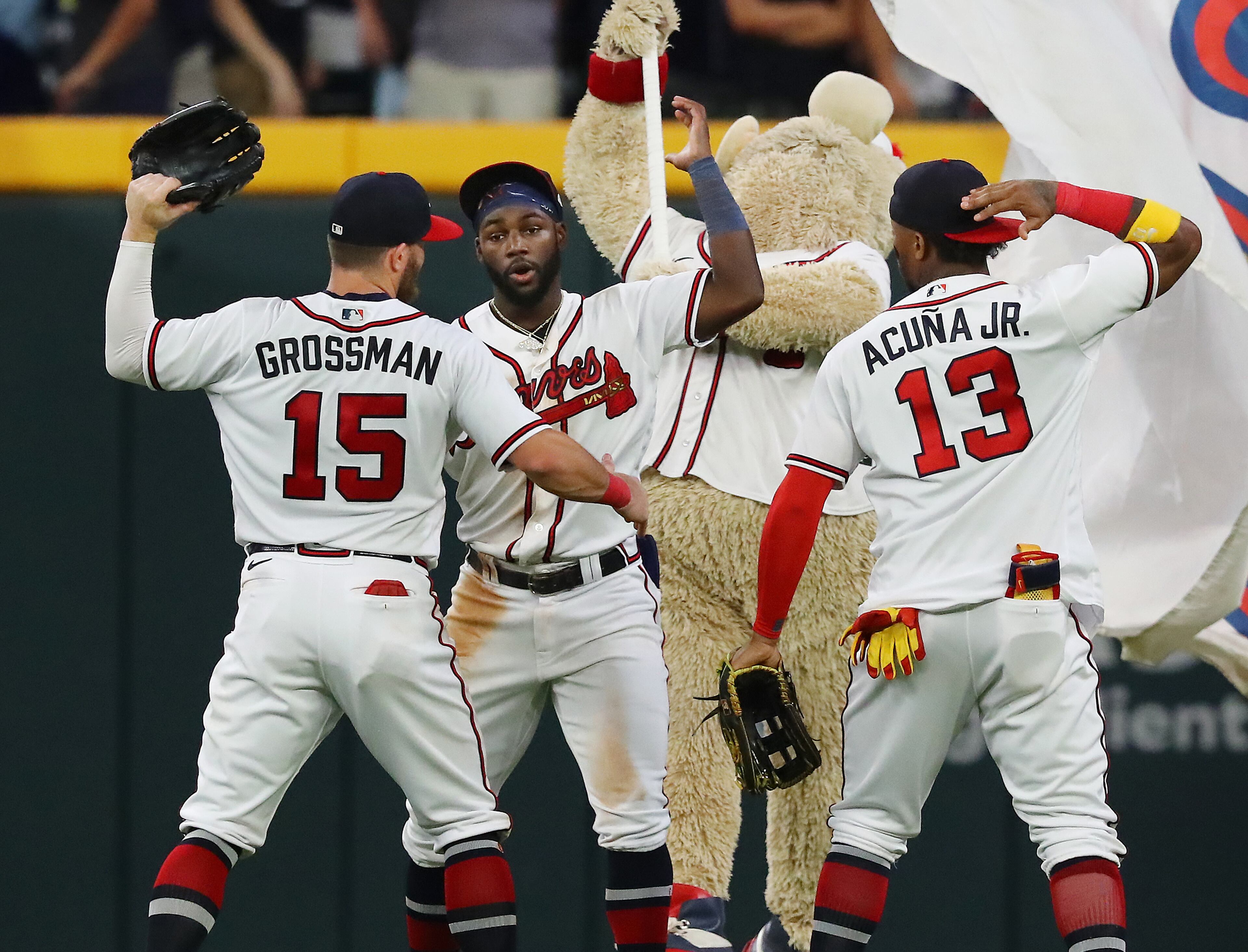 081822 Atlanta: Atlanta Braves outfielders Robbie Grossman (from left), Michael Harris, and Ronald Acuna celebrate a 3-2 victory over the New York Mets to take the series in a MLB baseball game on Thursday, August 18, 2022, in Atlanta. “Curtis Compton / Curtis Compton@ajc.com