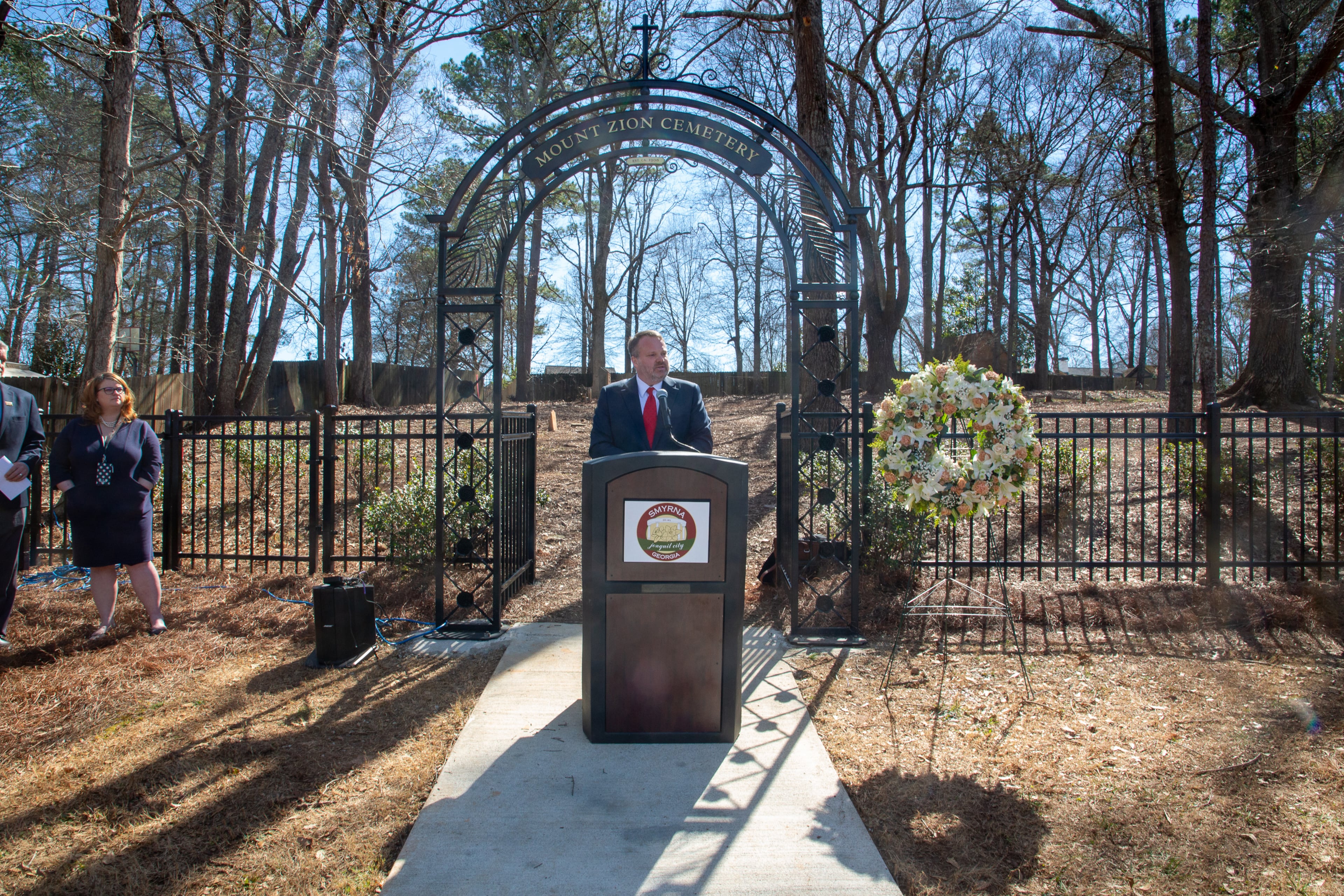 Councilman Travis Lindley talks to the crowd while standing in front of the new entrance of the Mount Zion Cemetery during the rededication ceremony in Smyrna on Sunday, February 20, 2022. (Photo: Steve Schaefer for The Atlanta Journal-Constitution)