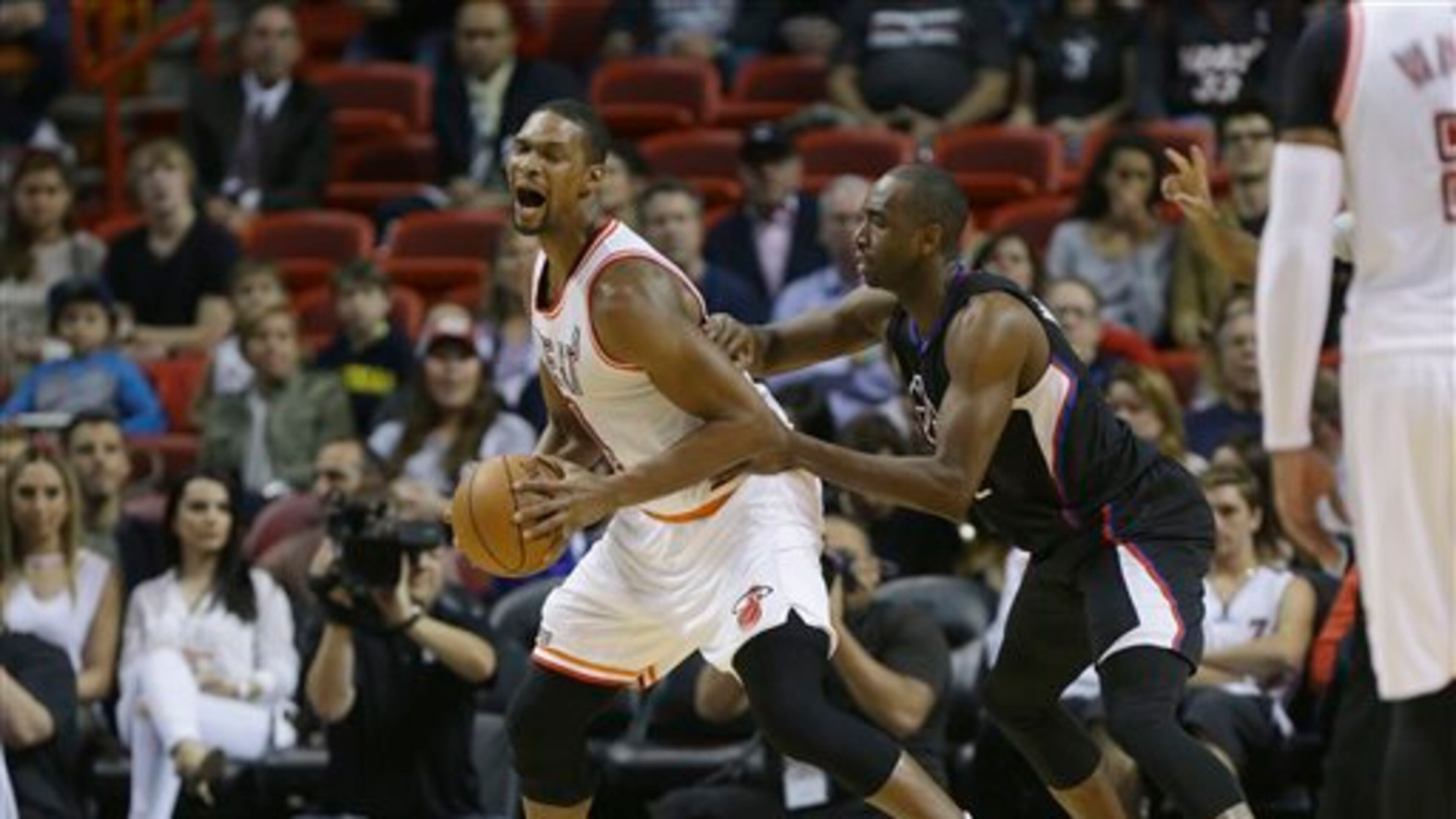 Miami Heat forward Chris Bosh, left, is defended by Los Angeles Clippers forward Luc Richard Mbah a Moute, right, during the first half of an NBA basketball game, Sunday, Feb. 7, 2016, in Miami. (AP Photo/Lynne Sladky)