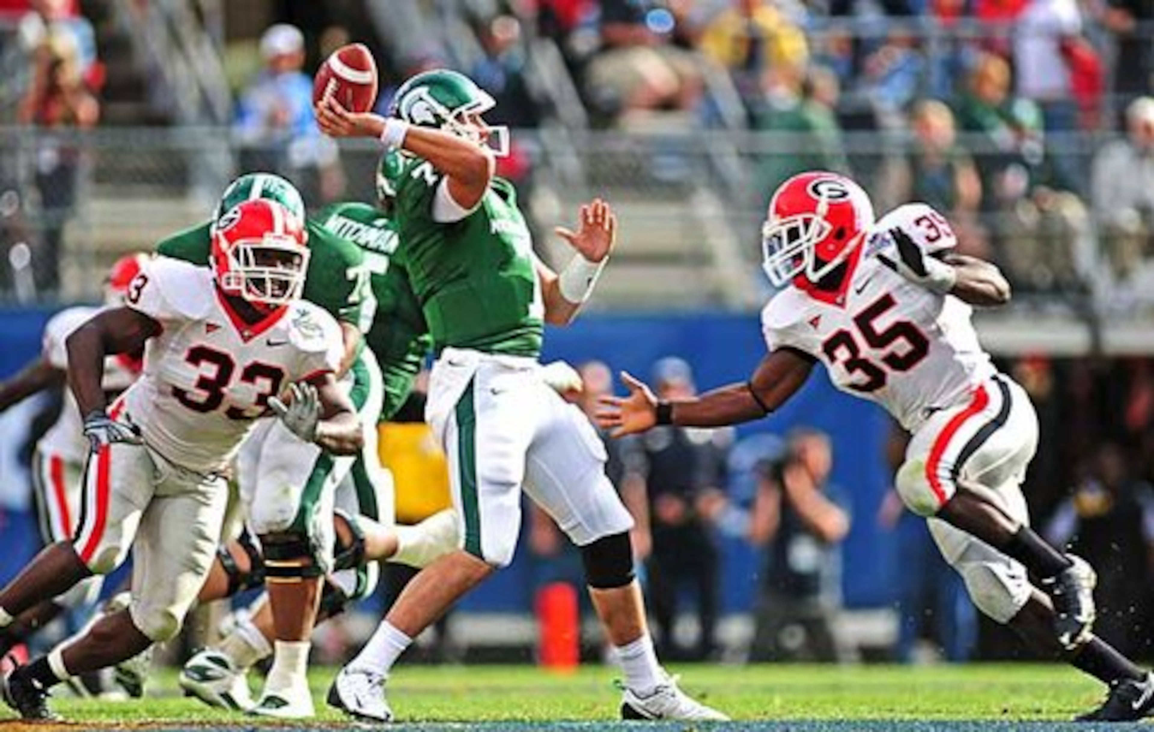 The Bulldogs defense emerged as one of the few bright spots during the first half of the Capital One Bowl. Powered by Georgia linebackers Rennie Curran (35) and Dannell Ellerbe (33), seen here preparing to tackle Michigan State quarterback Brian Hoyer (7), the Dogs held the Spartans to only six points in the half.