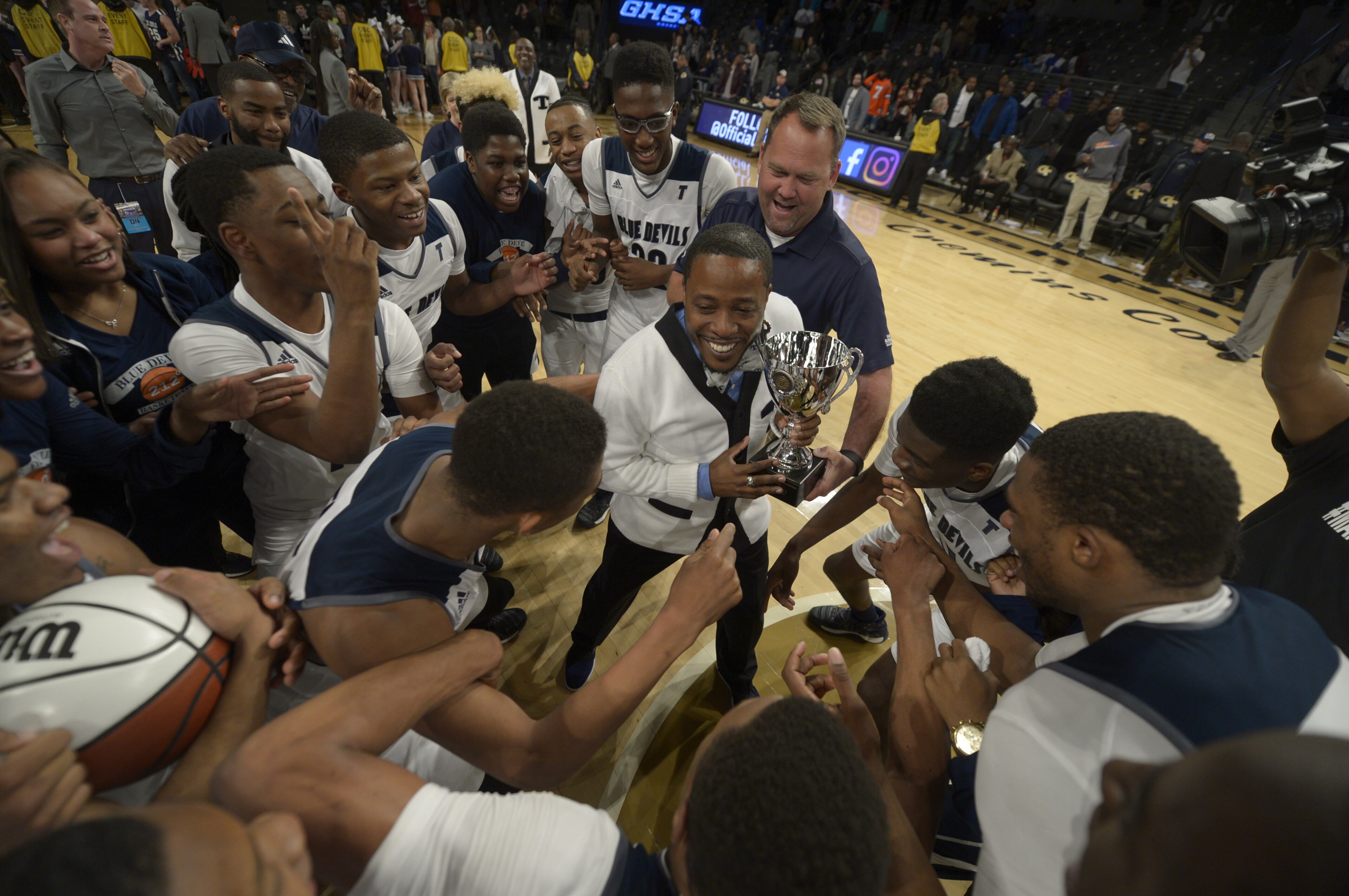 Atlanta, Ga. -- Tift County head coach Eric Holland (holding trophy) celebrates with his team after their 55-52 win over Norcross in a Class AAAAAAA state championship game at Georgia Tech's McCamish Pavillion Friday, March 10, 2017. SPECIAL/Daniel Varnado
