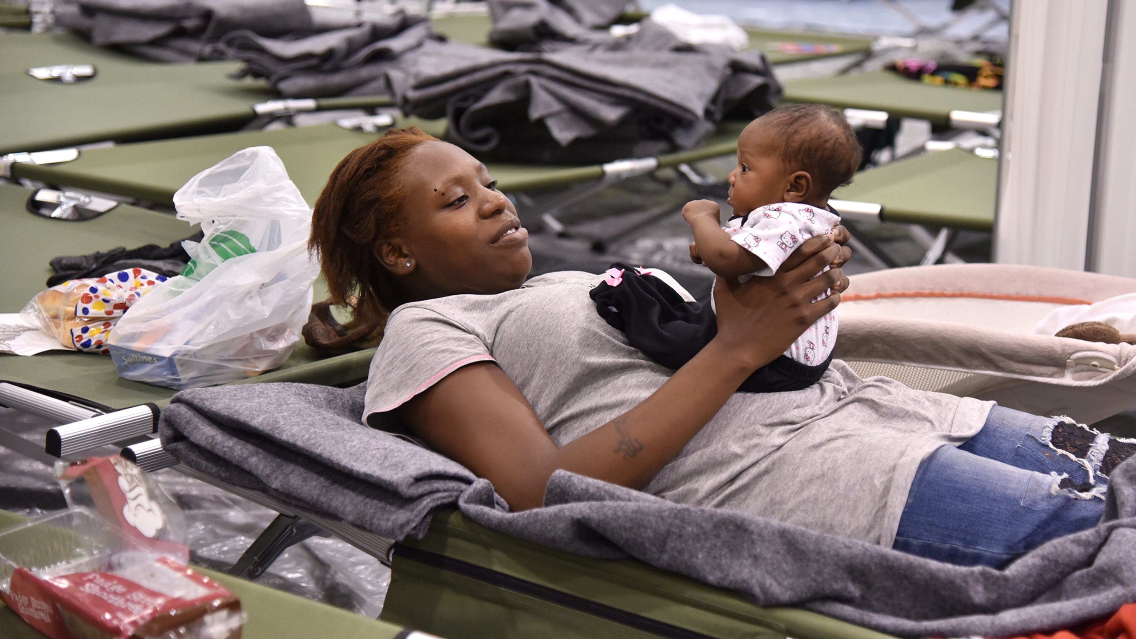 October 7, 2016 Macon, GA: Markita Riley and her two-month-old daughter Amaris from Brunswick, GA prepare to to spend the night in a Red Cross shelter in Macon Friday October 7, 2016 as hurricane Matthew hits the coast. BRANT SANDERLIN/BSANDERLIN@AJC.COM