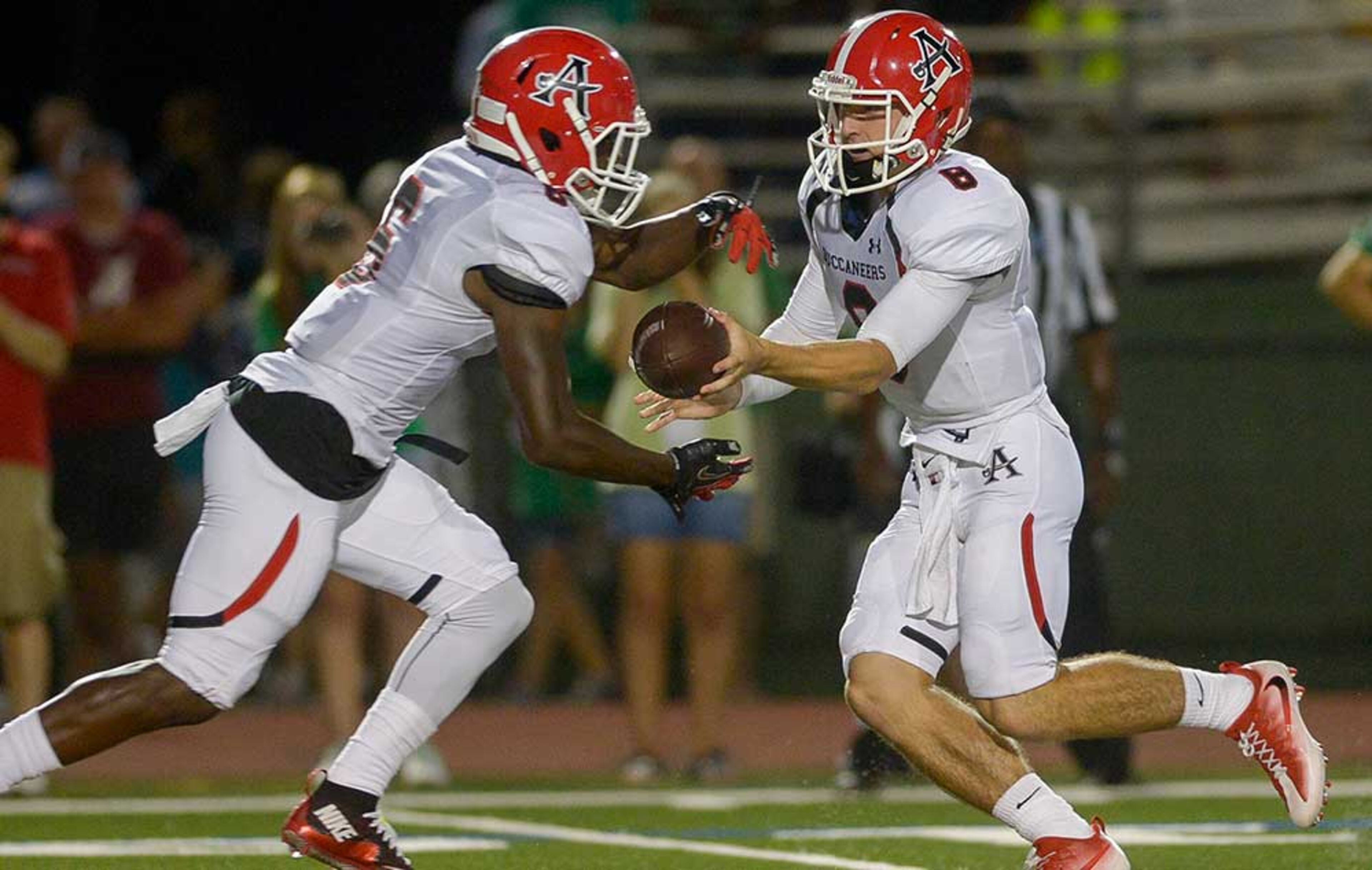 Allatoona senior QB Tate Tatum (8) hands off to Adrian Boyd during Friday's game.