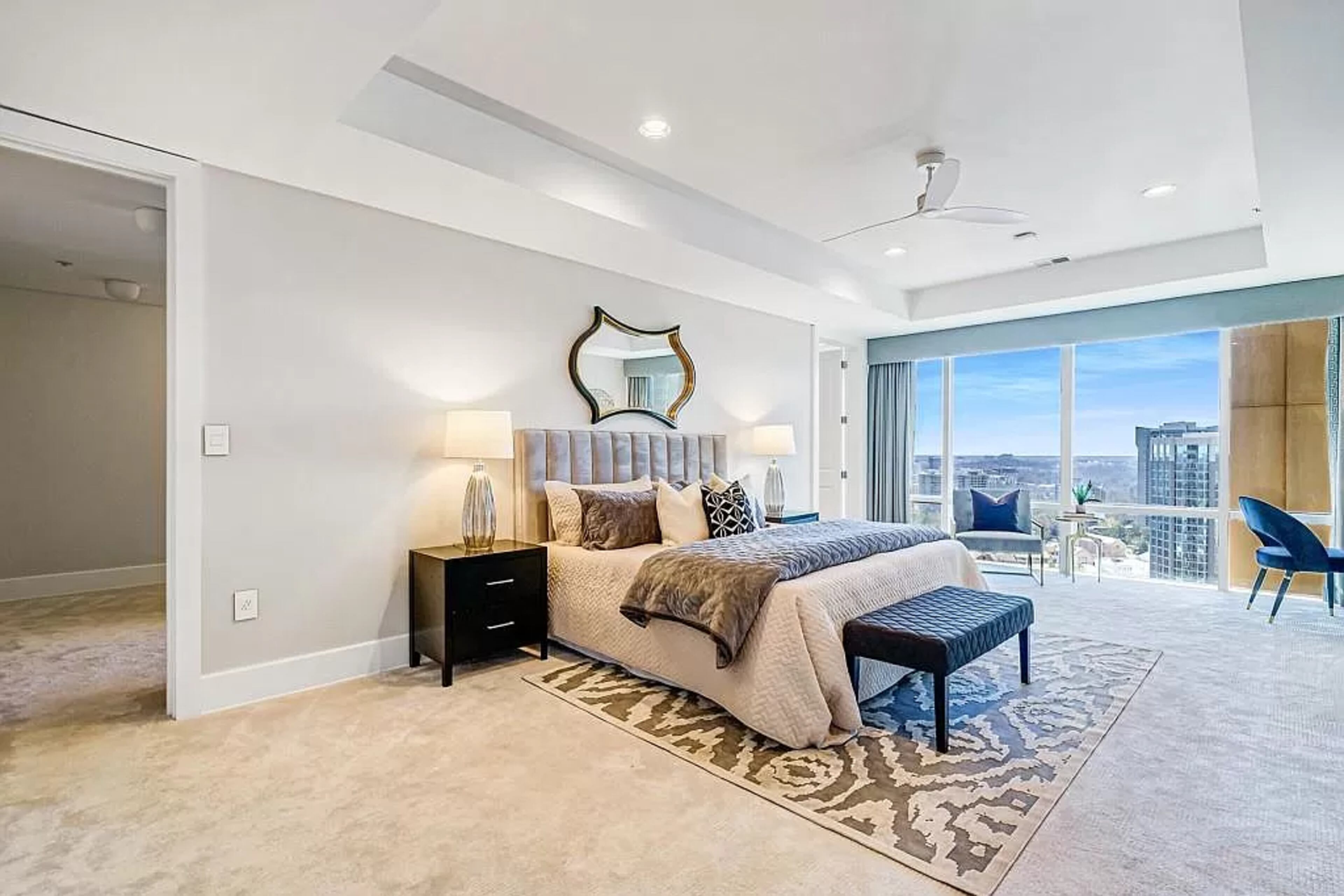 This luxurious en suite retreat includes dual vanities, a seamless glass shower and a freestanding oval bathtub.