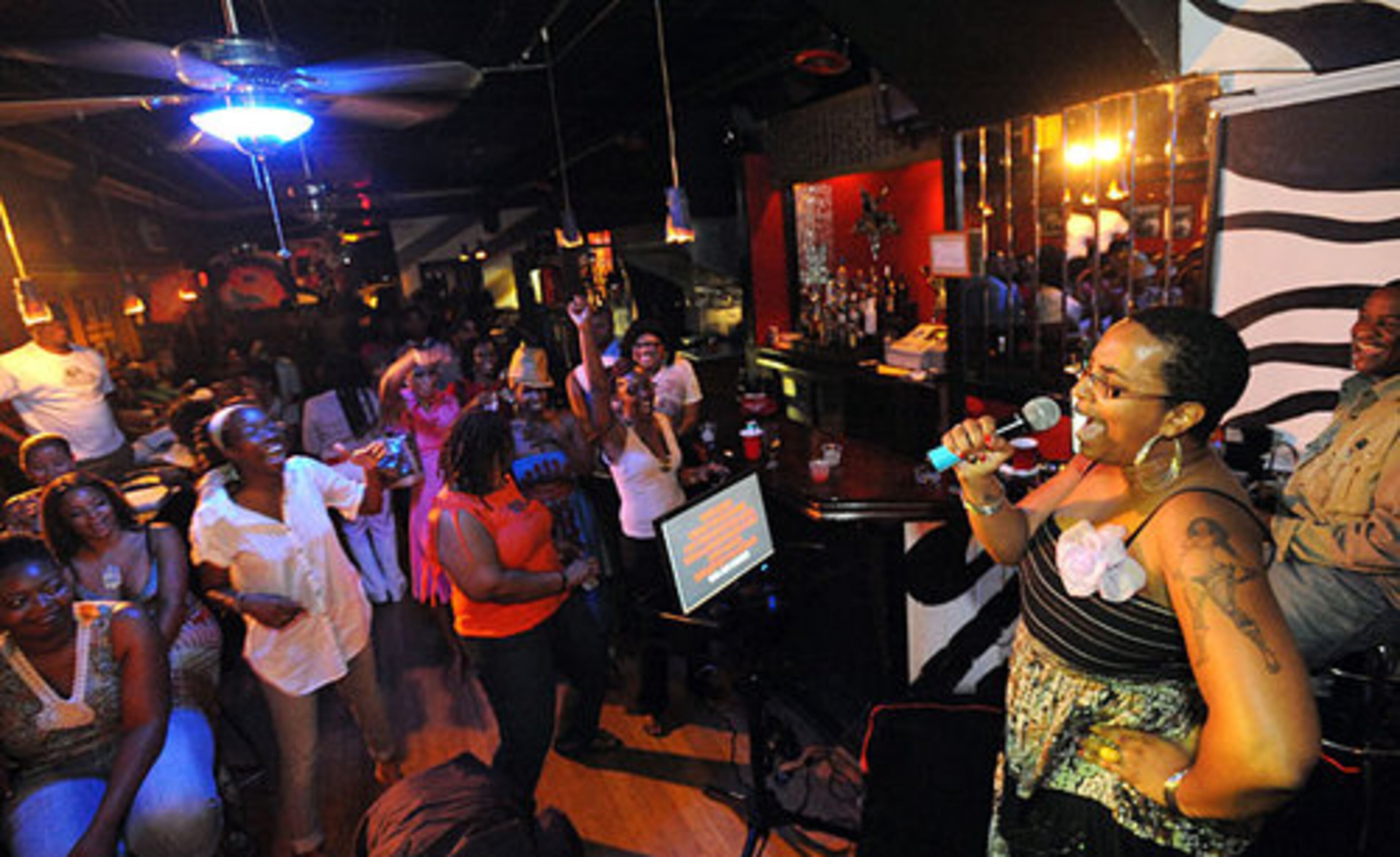 Kimberly Stewart, a Karaoke Disciple, takes the stage during a recent Yo! Karaoke night at Pal's Lounge on Auburn Avenue in Atlanta. People still talk about her performance a few months ago as both Ashford and Simpson.