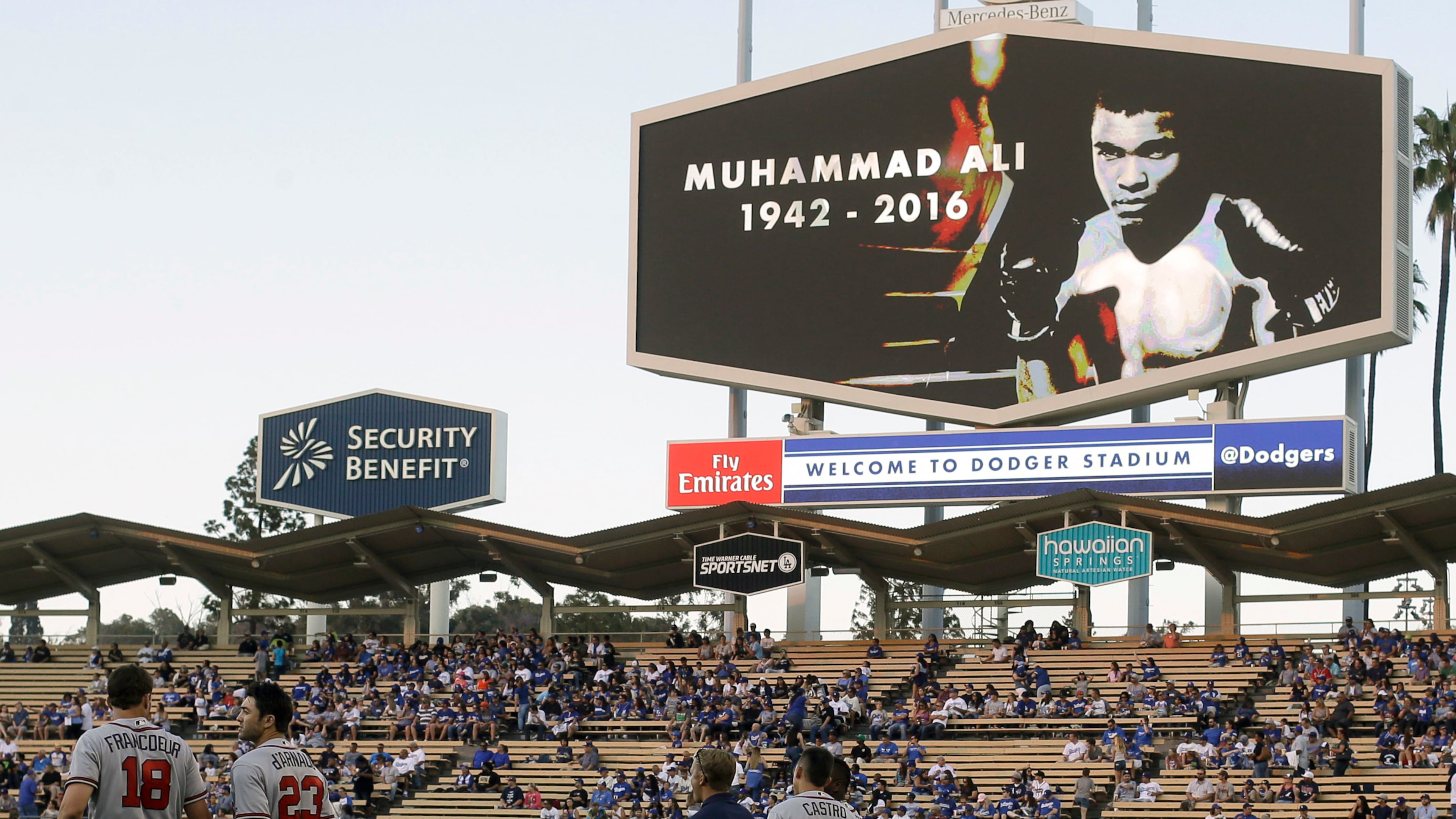 Members of the Atlanta Braves stand on the field during a moment of silence for boxer Muhammad Ali before a baseball game between the Los Angeles Dodgers and the Atlanta Braves in Los Angeles, Saturday, June 4, 2016. (AP Photo/Chris Carlson)