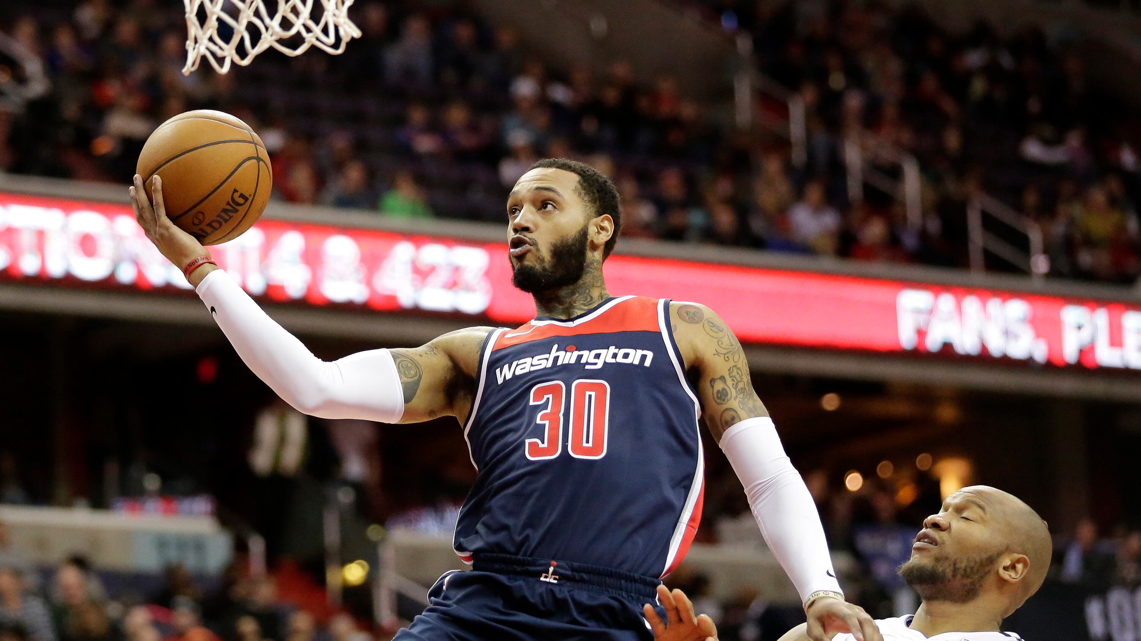 Washington Wizards forward Mike Scott (30) drives to the basket against Orlando Magic forward Marreese Speights (5) during an NBA basketball game against the Orlando Magic Saturday, Dec. 23, 2017, in Washington. (AP Photo/Mark Tenally)