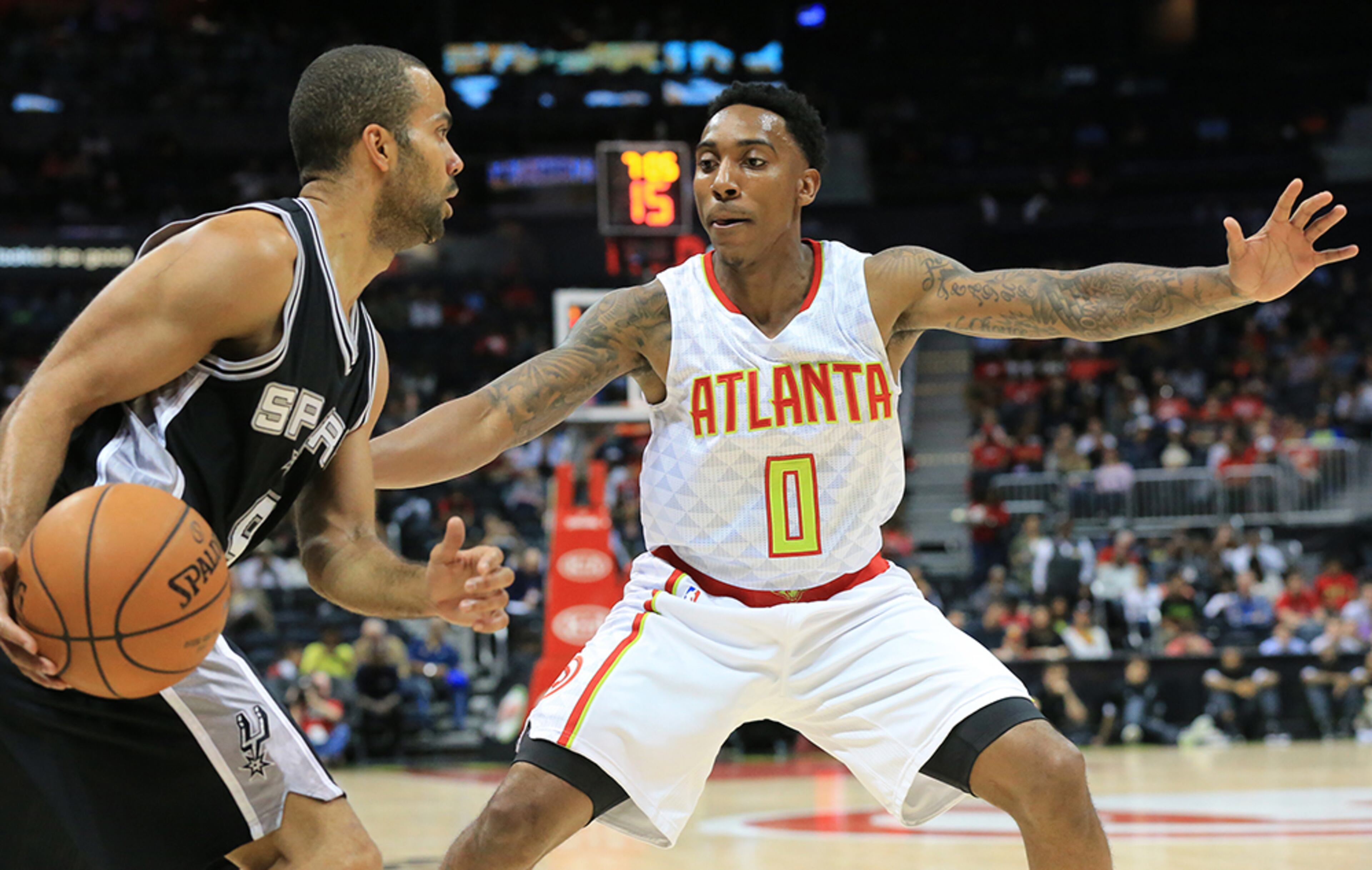 Hawks guard Jeff Teague defends against the Spurs' Tony Parker during the first period in their preseason matchup Wednesday, Oct. 14, 2015, in Atlanta.
