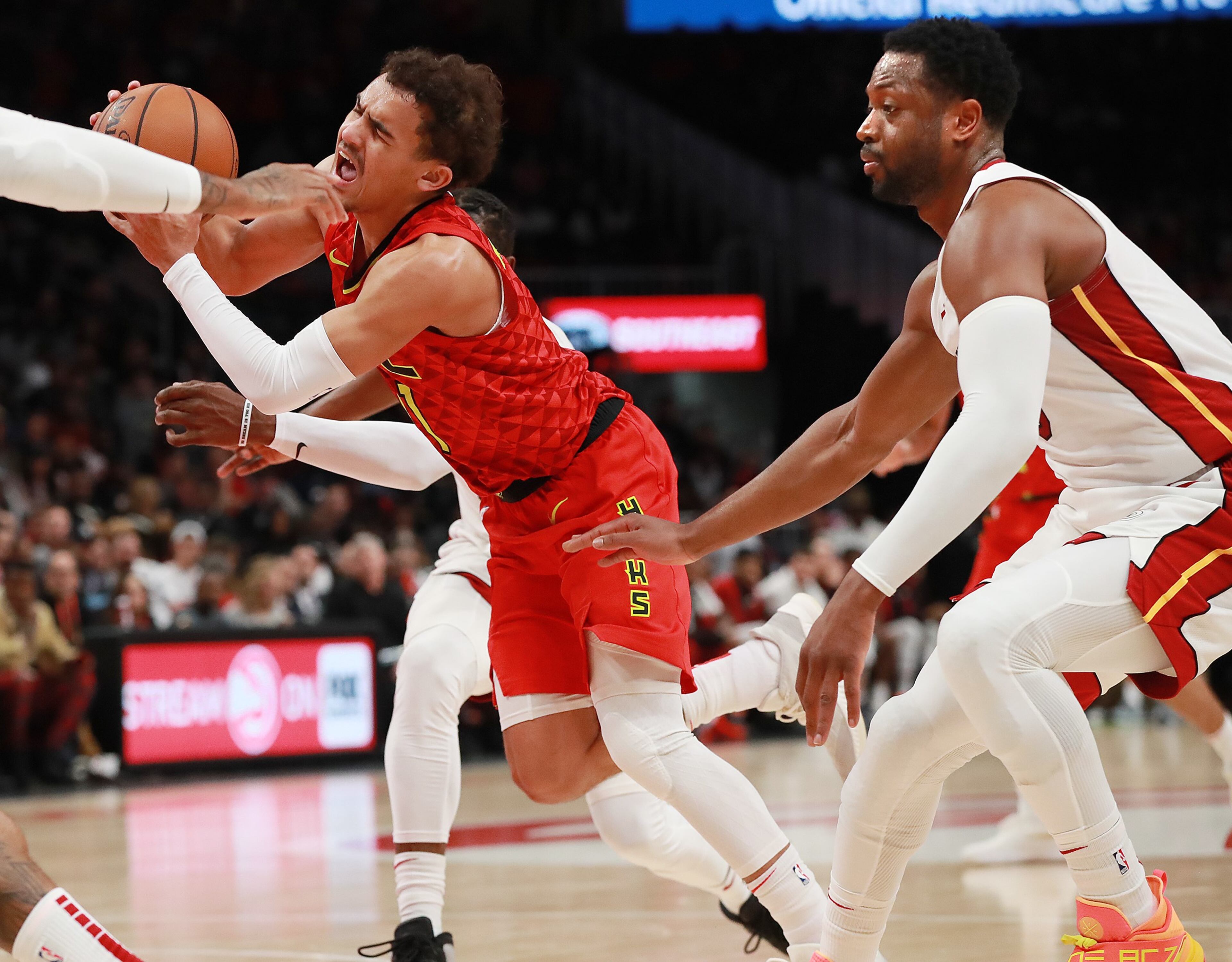Jan. 06, 2019 Atlanta: Atlanta Hawks guard Trae Young struggles to maintain control while driving against Miami Heat Dwyane Wade during the first half in a NBA basketball game at State Farm Arena on Sunday, Jan. 6, 2019, in Atlanta. Curtis Compton/ccompton@ajc.com