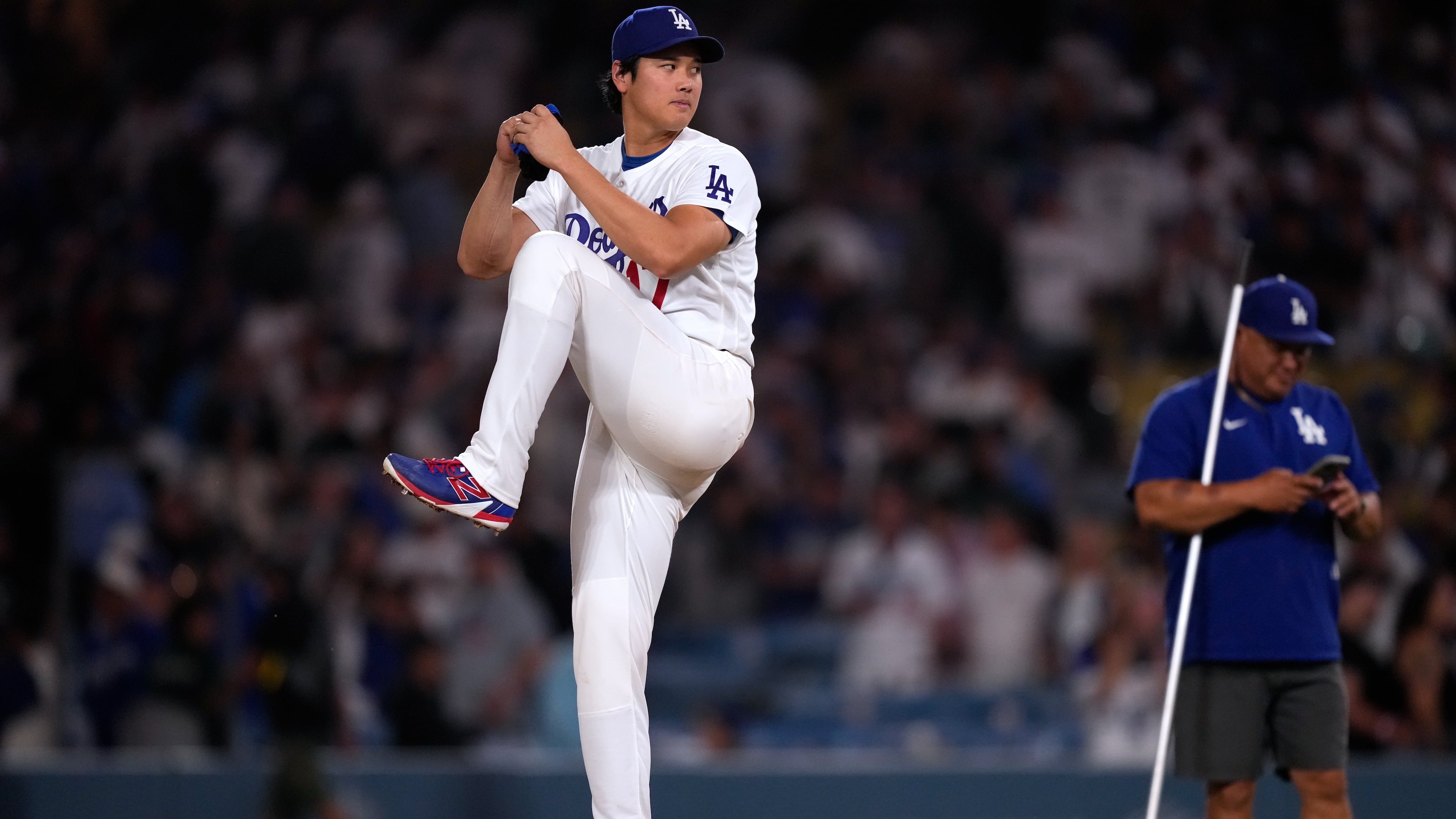 Los Angeles Dodgers' Shohei Ohtani fakes a pitch after the Dodgers defeated the against the Colorado Rockies in a baseball game Wednesday, July 8, 2026, in Los Angeles. (AP Photo/Mark J. Terrill)