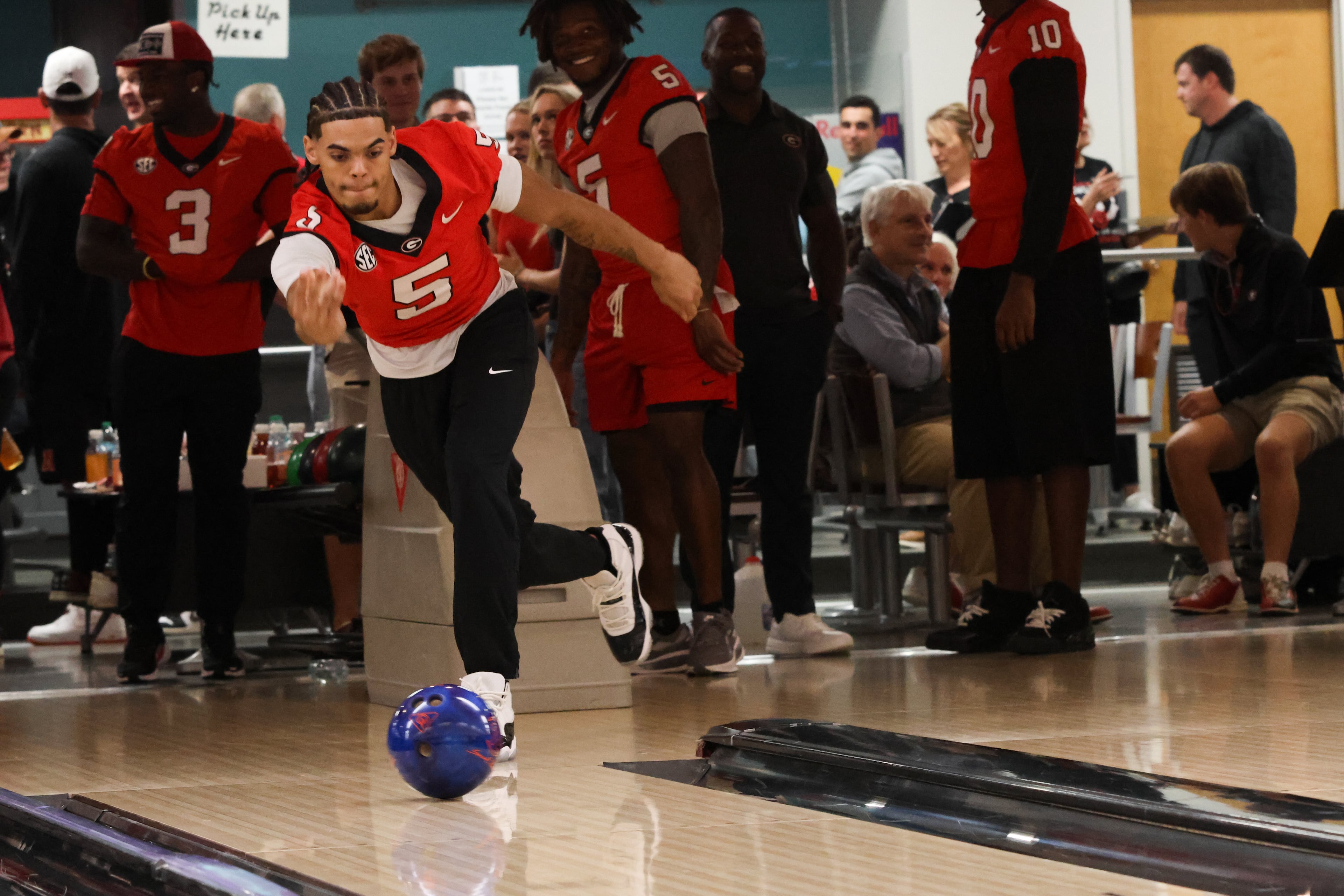 UGA wide receiver Noah Thomas (5) bowls during the third annual Chick-fil-A Dawg Bowl fundraiser for Parkinson’s and Crohn’s disease research at Showtime Bowl in Athens on Wednesday, Oct. 22, 2025. (C.J. Bartunek for the AJC)