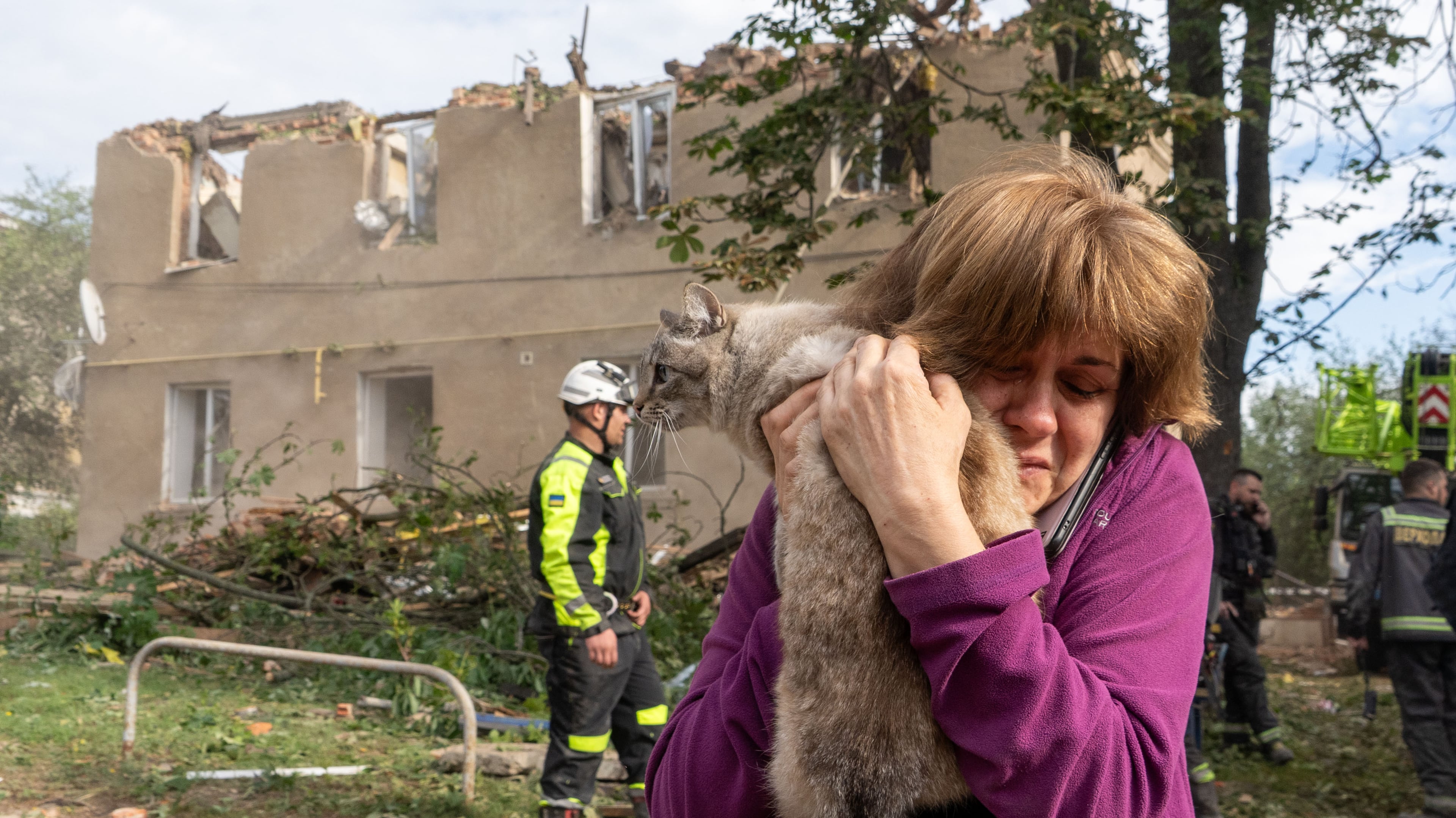 A woman holds her cat after it being found during search and rescue works in the damaged residential building following Russia's missile attack in Kharkiv, Ukraine, Saturday, June 20, 2026. (AP Photo/Andrii Marienko)