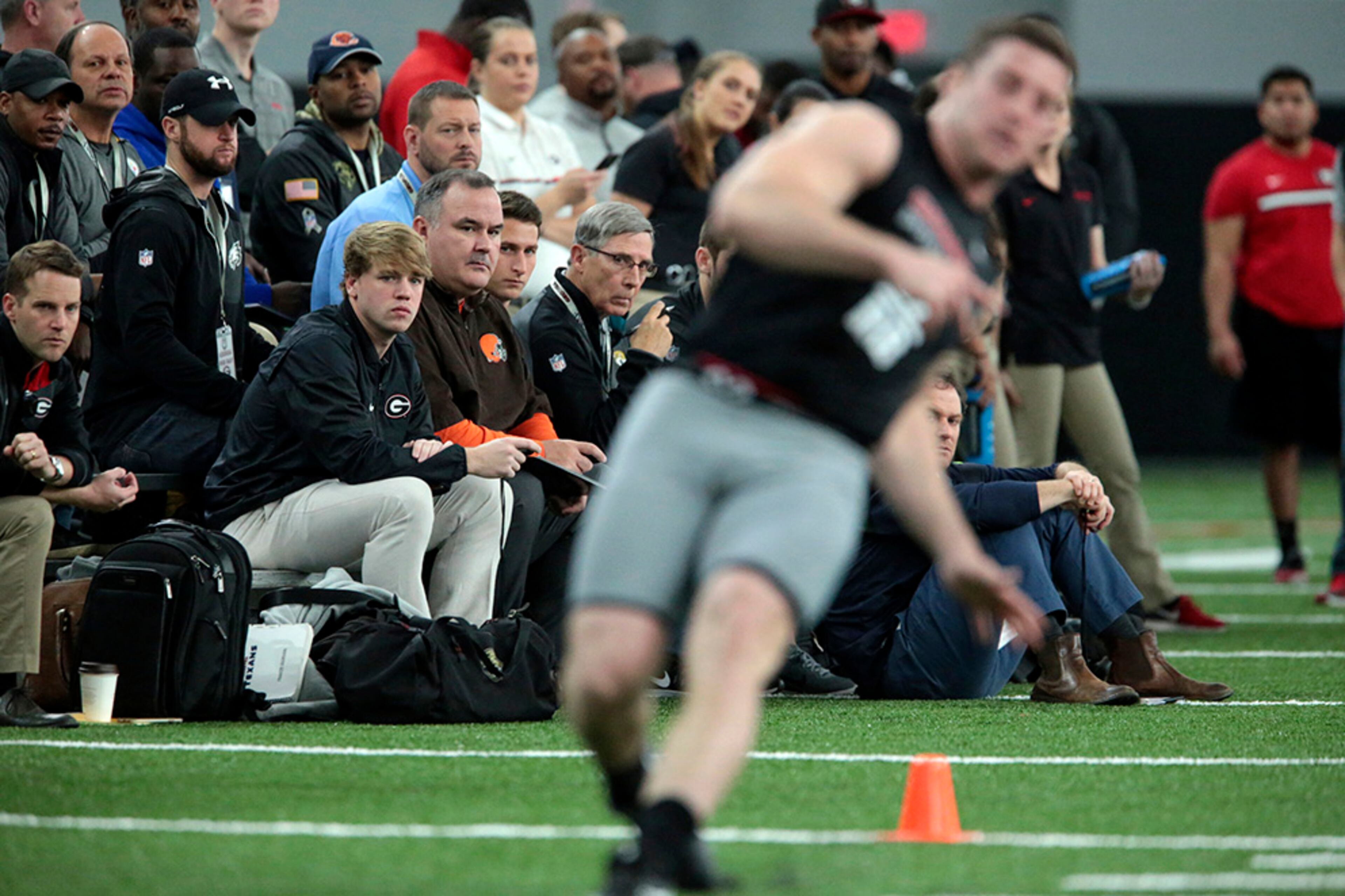 NFL personnel watch UGA players run drills during pro day at the University of Georgia in Athens, Ga., Wednesday, March 15, 2017. (John Roark/Athens Banner-Herald via AP)