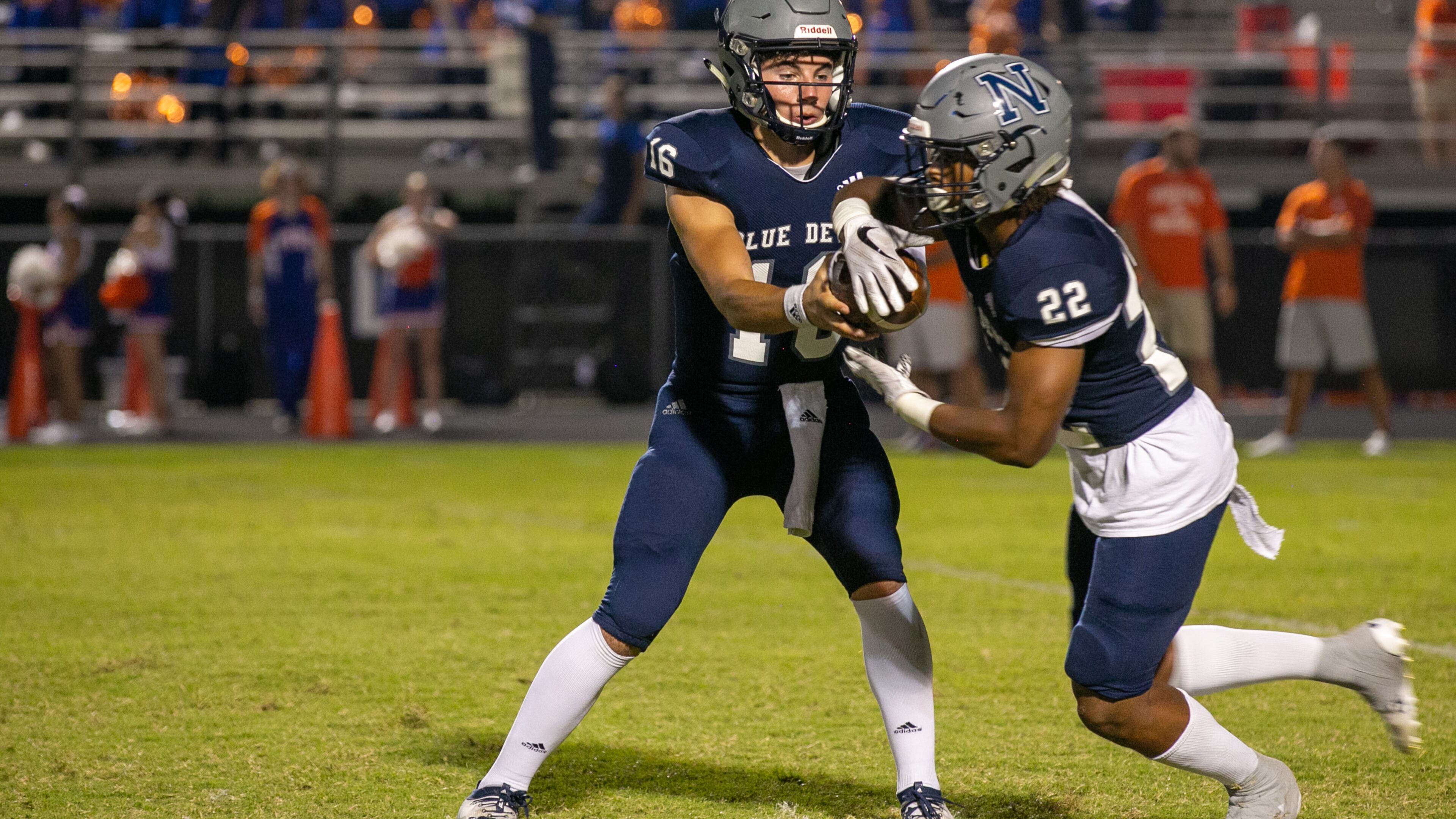 Norcross' Mason Kaplan (16) hands off the ball to Norcross' Kaleb Jackson (22) during game in October 2019. (Rebecca Wright/For the AJC)