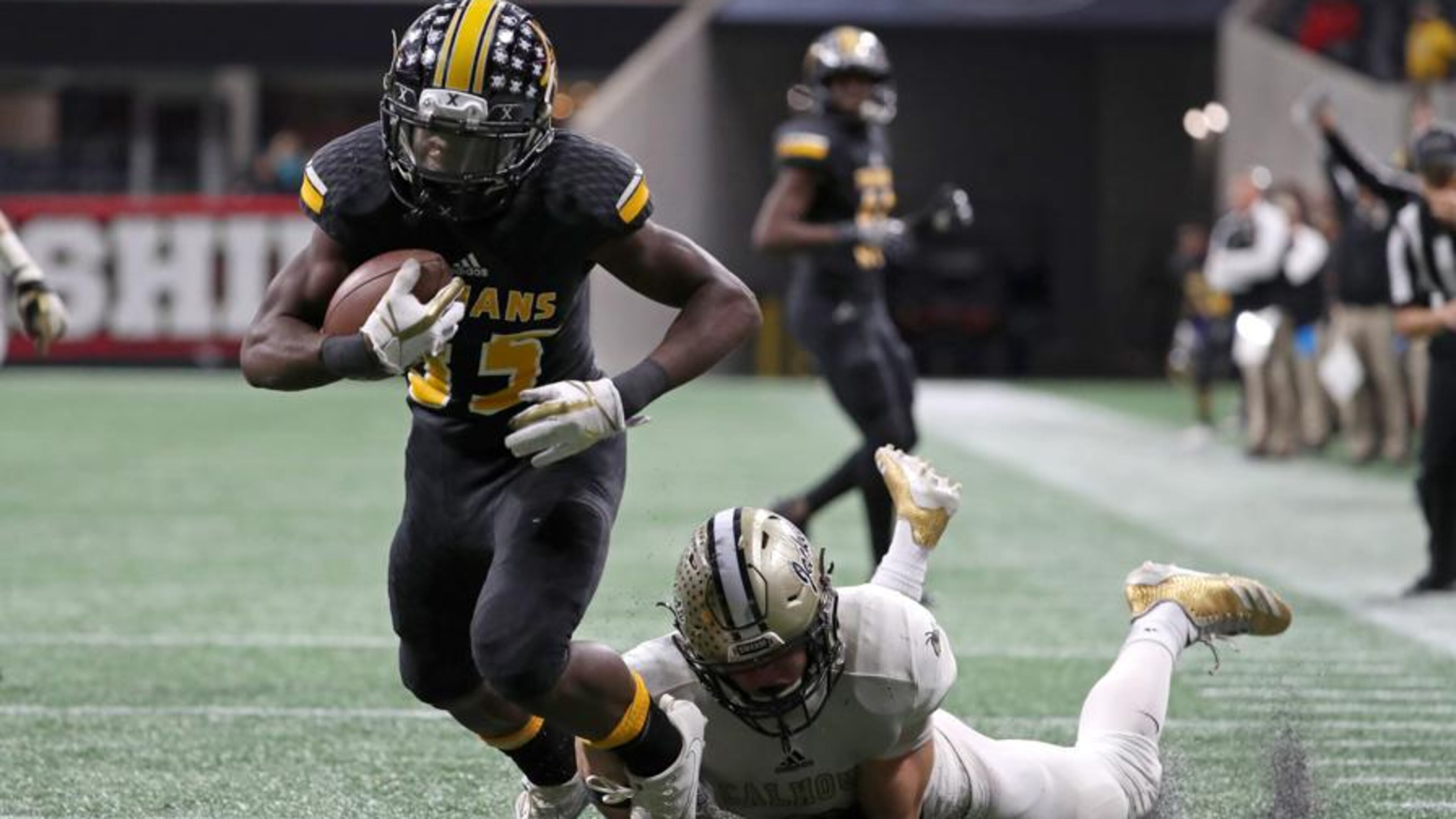On 4th down, Peach County wide receiver Noah Whittington (35) is tackled by Calhoun defensive back Brannon Spector (3) after apparently catching a pass deep in Calhoun territory in the fourth quarter of the Class AAA Championship at Mercedes-Benz Stadium Friday, December 8, 2017, in Atlanta. The play was ruled an incomplete pass turning the ball over on downs. Calhoun won 10-6. PHOTO / JASON GETZ