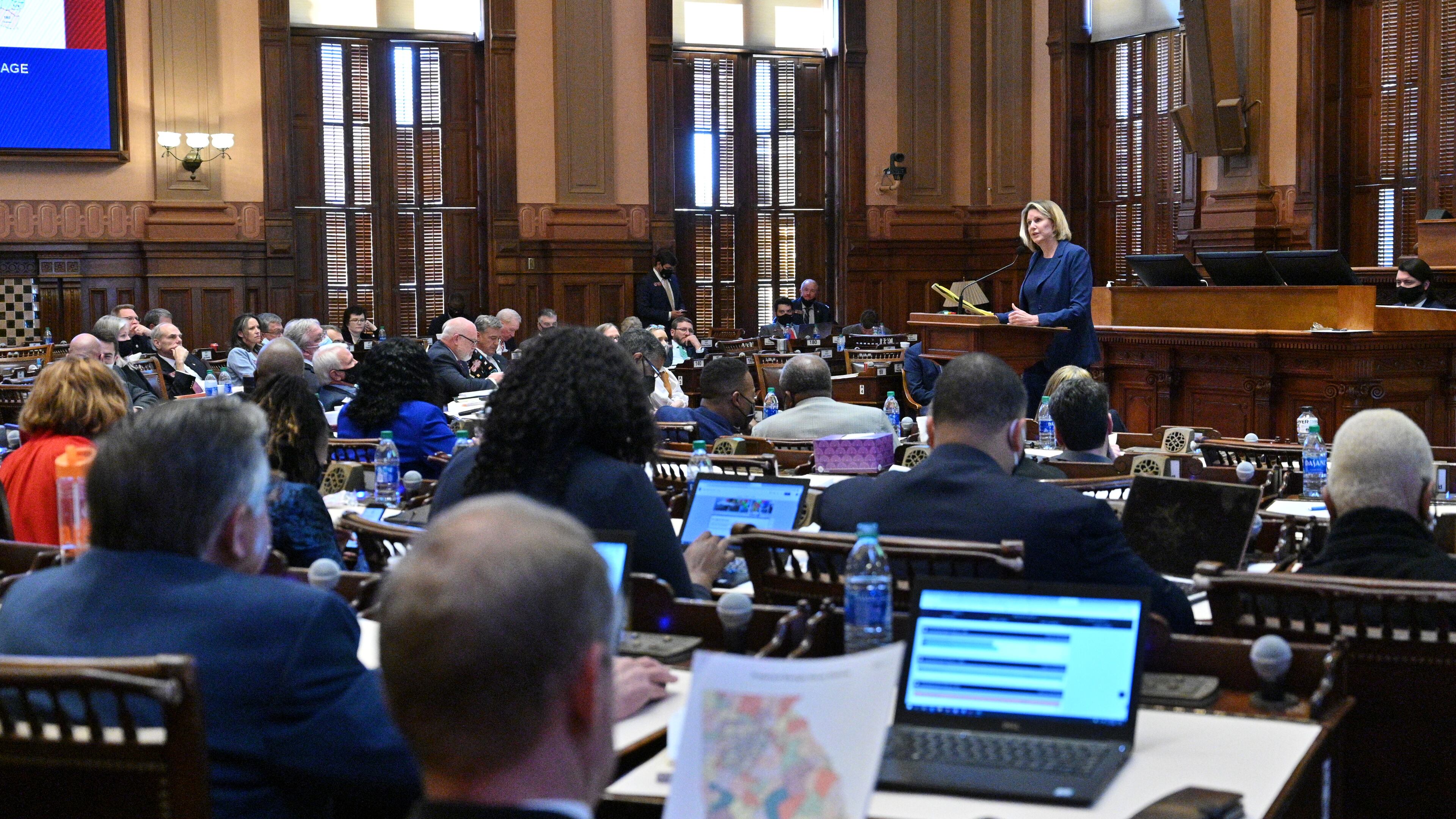 House Speaker Pro Temp Rep. Jan Jones speaks in favor of HB 1 EX as Rep. Bill Werkheiser (R-Glennville), foreground, looks at proposed maps in the House Chambers during Day 6 of the special session at the Georgia State Capitol in Atlanta on Wednesday, November 10, 2021. (Hyosub Shin / Hyosub.Shin@ajc.com)