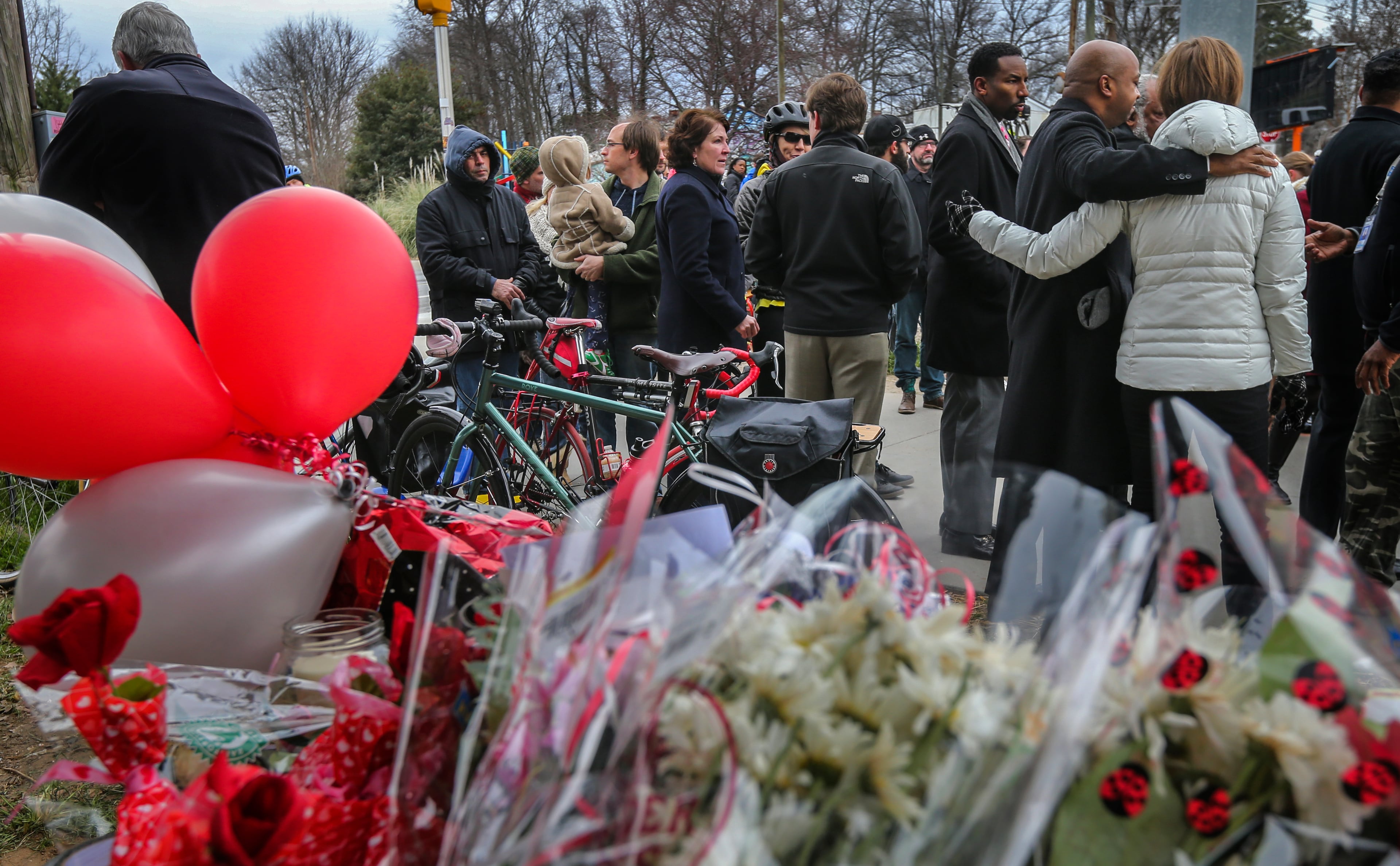 A group gathered at the memorial for Alexia Hyneman after the Grady High School freshman was hit and killed while riding her bicycle at 10th Street and Monroe Drive in 2016. (John Spink/AJC)