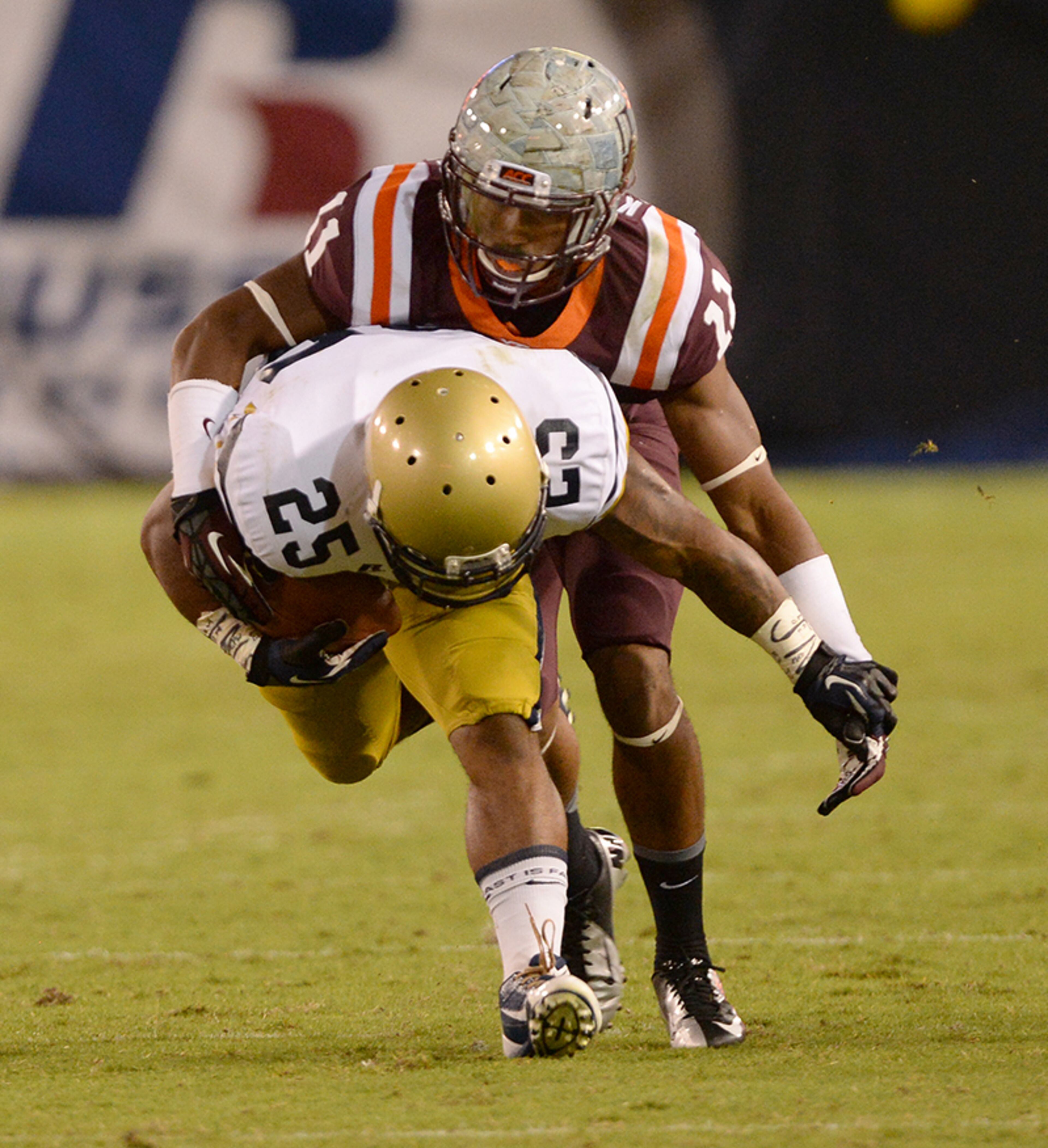 Tech A-Back Robert Godhigh (25) is tackled by Virginia Tech's Kendall Fuller (11).